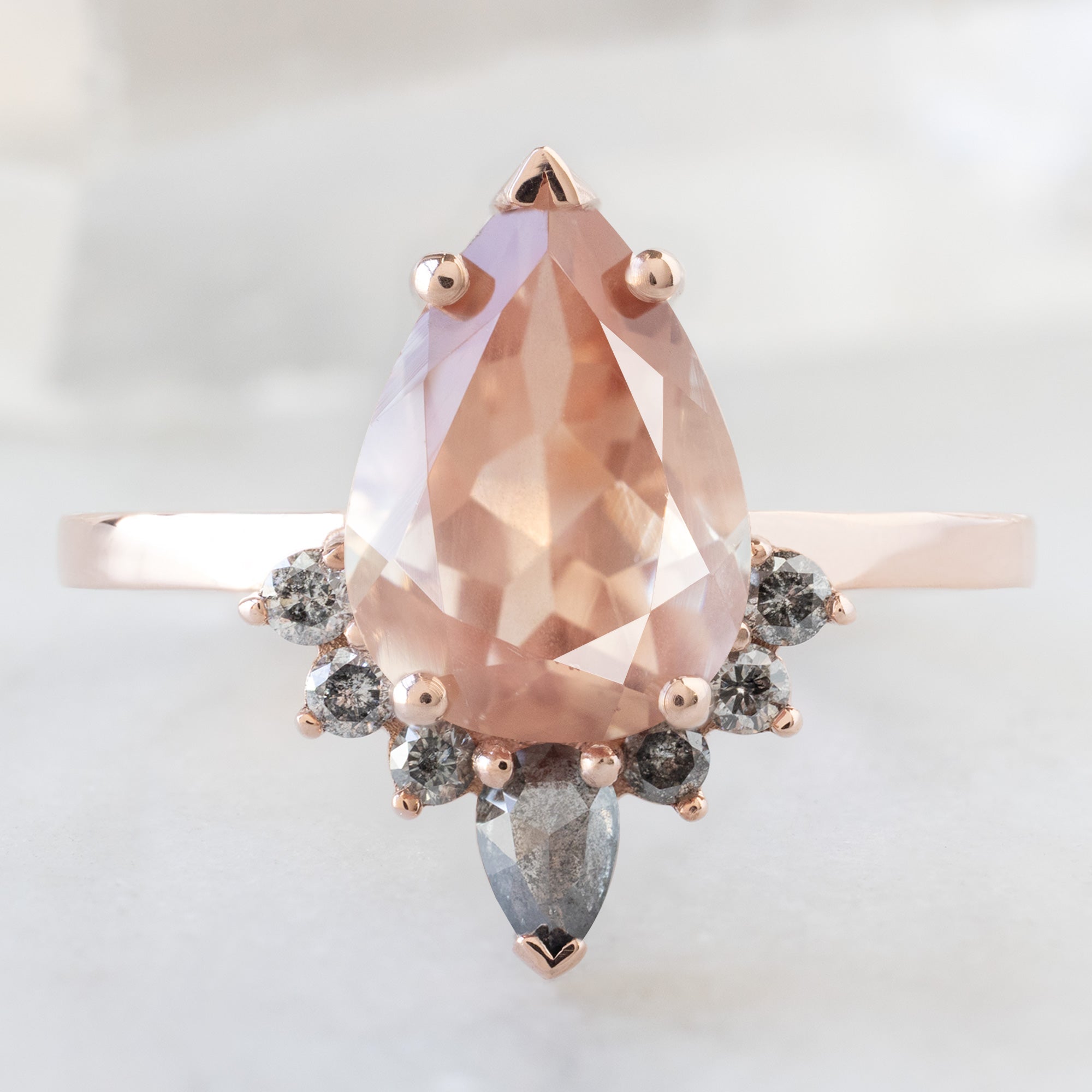 The Aster Ring with a 1.92ct Pear Sunstone in 14K Rose Gold on White Marble