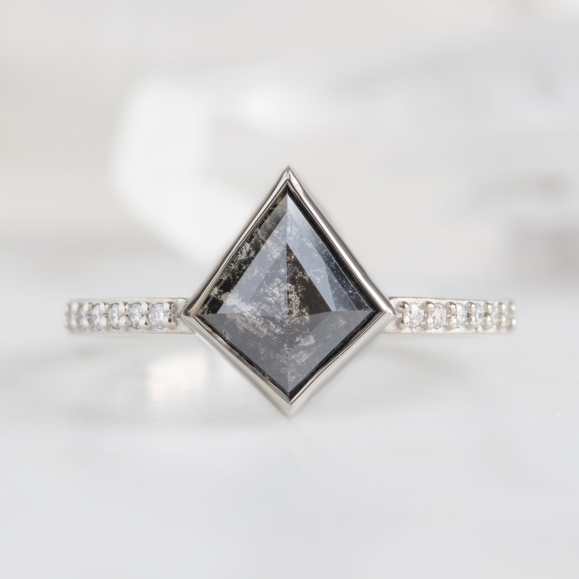 The Willow Ring with a 1.19ct Kite Black Diamond in 14K White Gold on White Marble