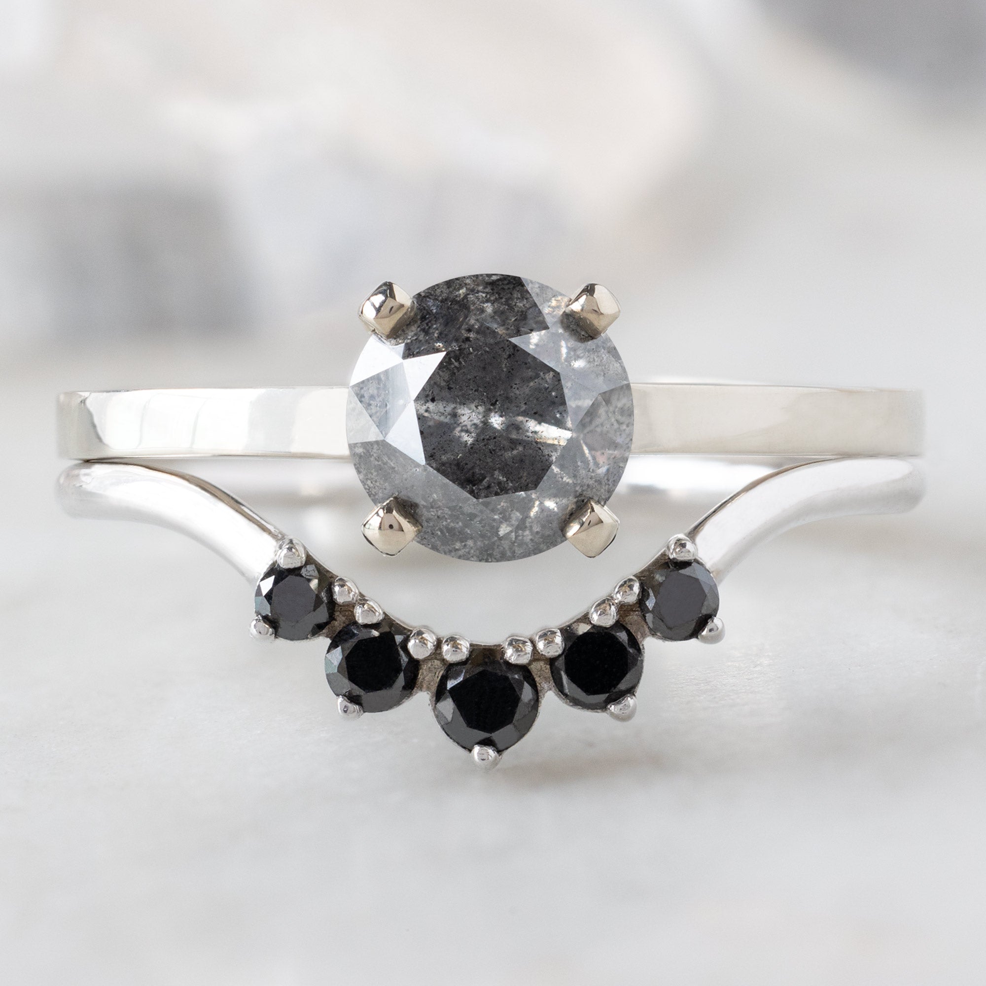The Bryn Ring with a 1.01ct Round Salt and Pepper Diamond in 14K White Gold Stacked with the Round Black Diamond Sunburst Stacking Band