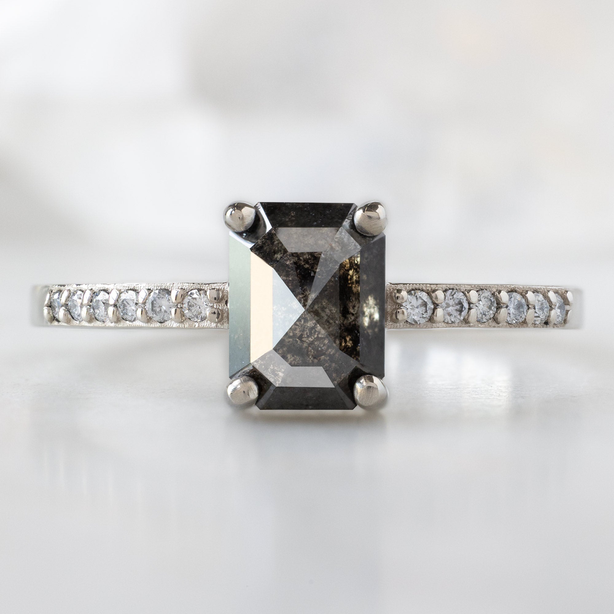 The Willow Ring with a 1.05ct Emerald Cut Black Diamond in 14K White Gold on White Marble