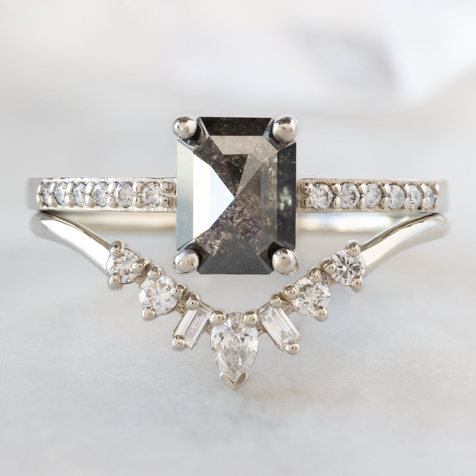 The Willow Ring with a 1.05ct Emerald Cut Black Diamond in 14K White Gold Stacked with the White Diamond Geometric Diamond Sunburst Stacking Band