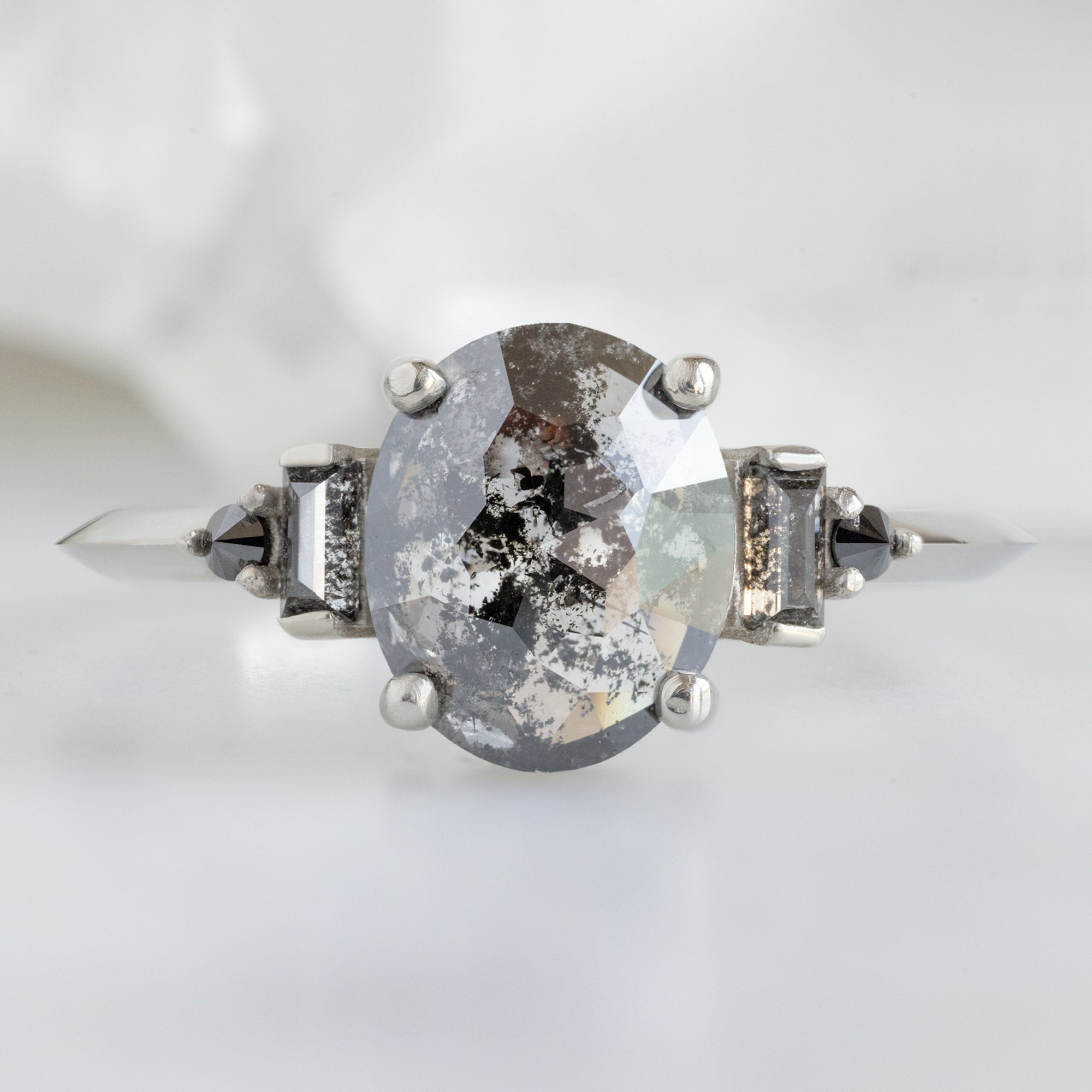 The Primrose Ring with a 1.32ct Oval Salt and Pepper Diamond in 14K White Gold on White Marble