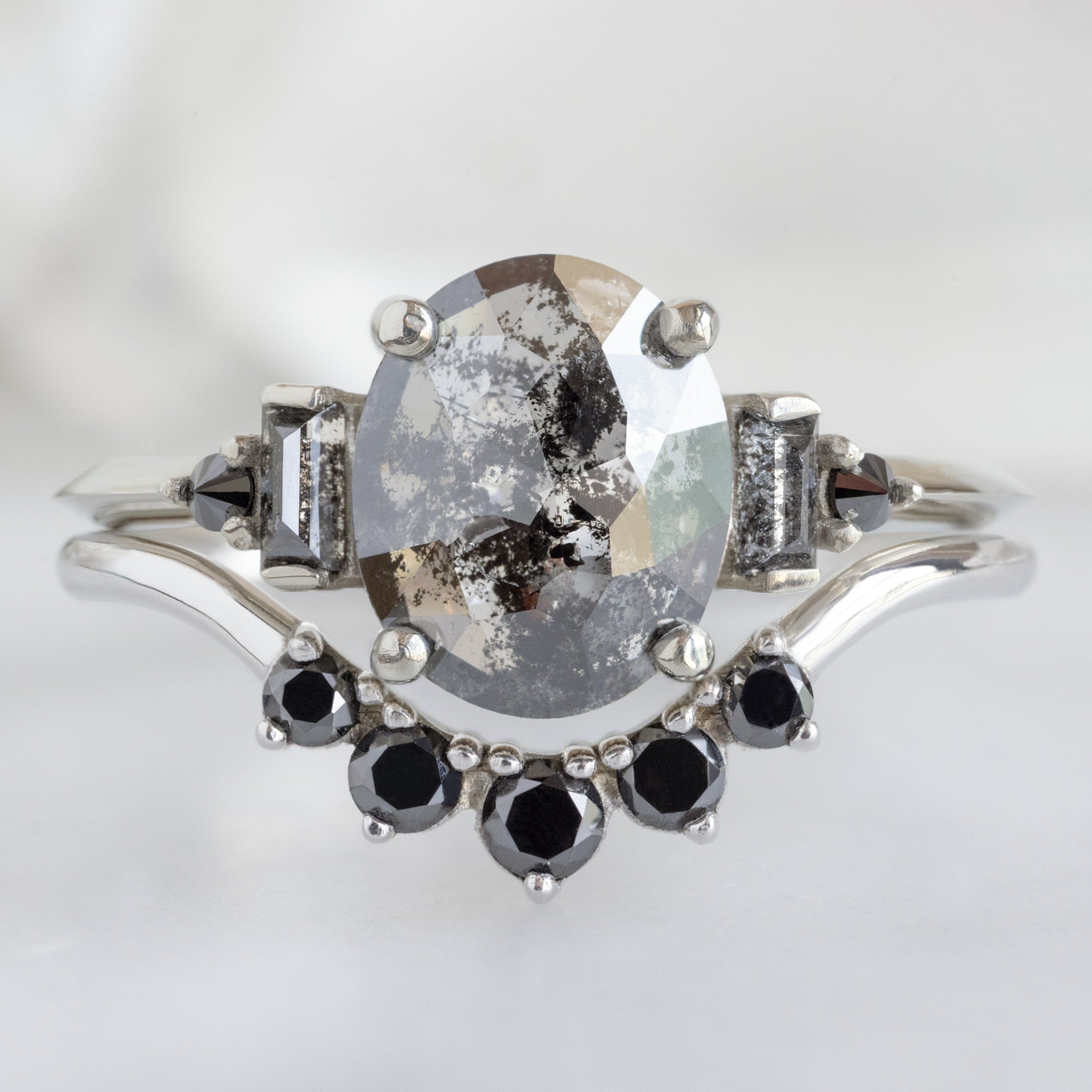 The Primrose Ring with a 1.32ct Oval Salt and Pepper Diamond in 14K White Gold Stacked with the Round Black Diamond Sunburst Stacking Band