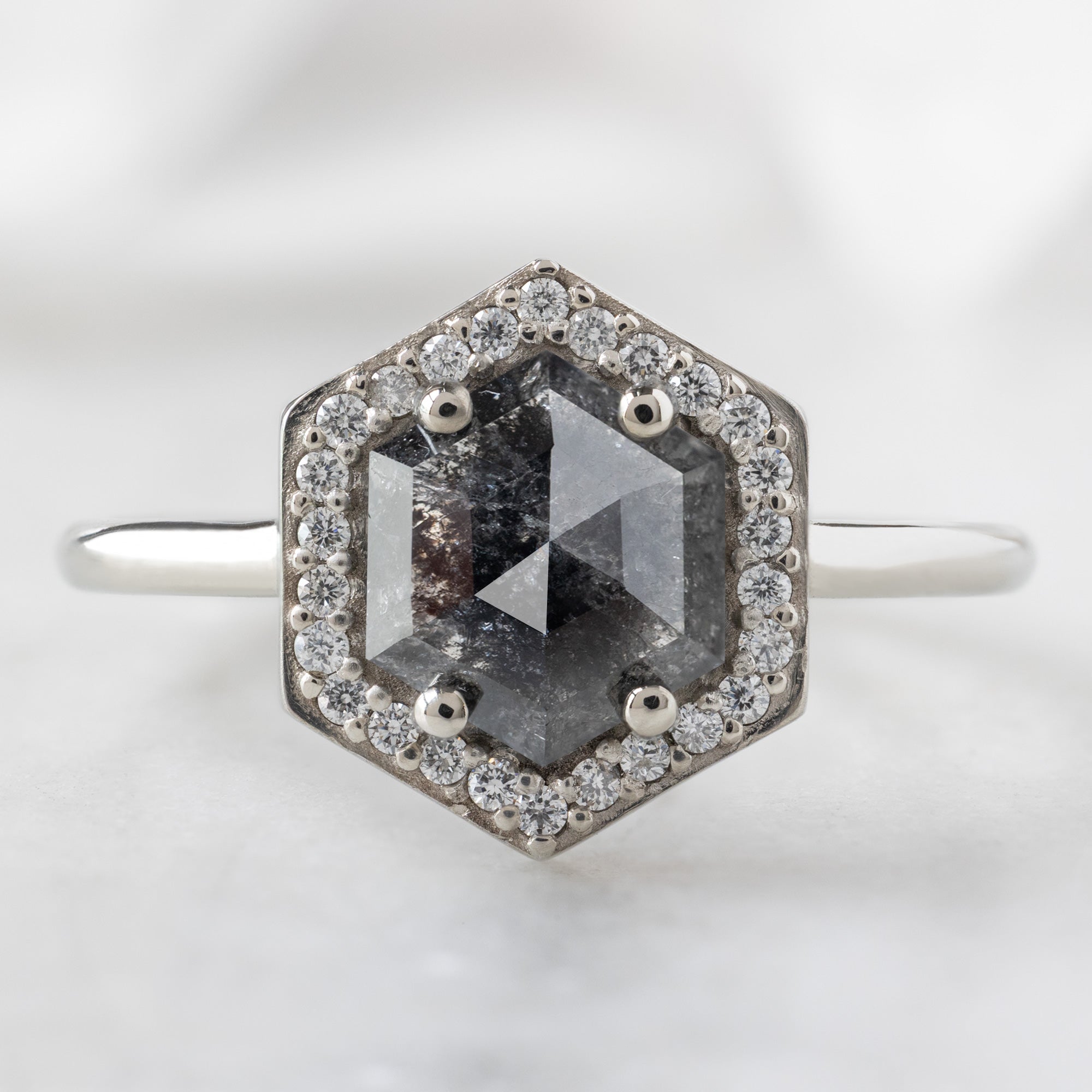 The Dahlia Ring with a 1.08ct Hexagon Black Diamond in 14K White Gold on White Marble