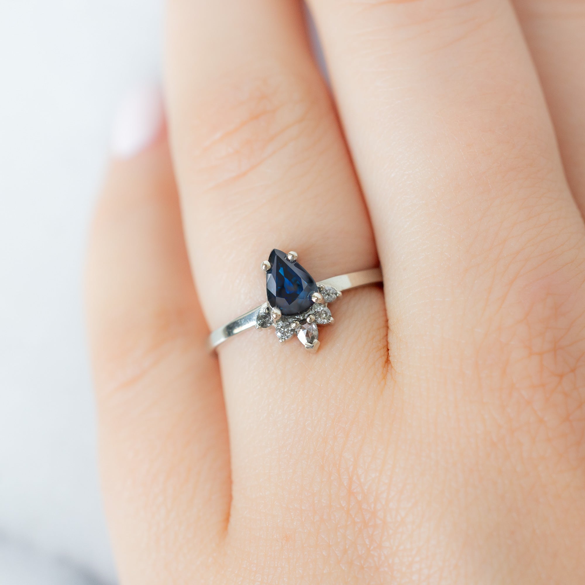 The Aster Ring with a 0.90ct Pear Blue Sapphire in 14K White Gold on Model