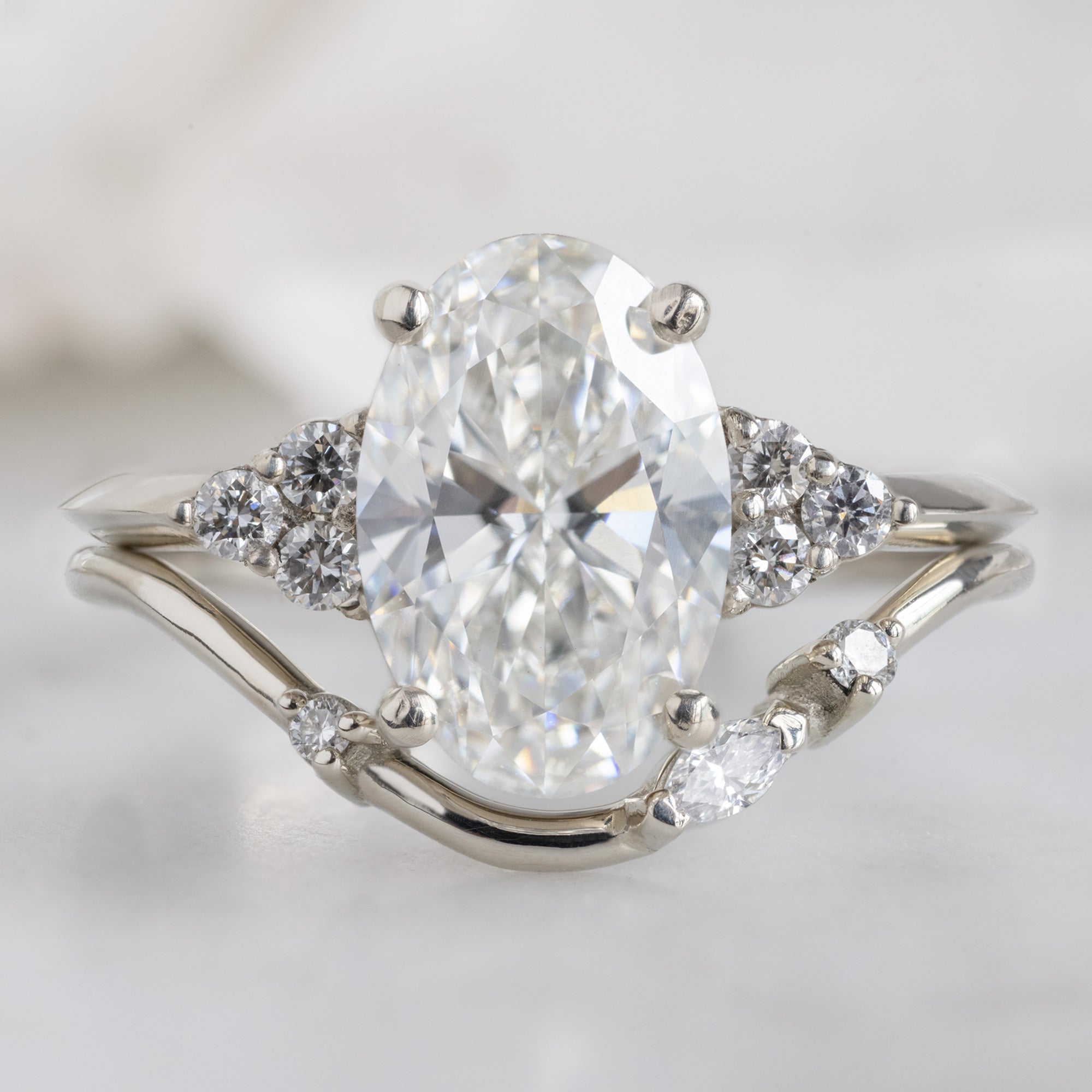 The Ivy Ring with a 1.88ct Oval Lab Grown White Diamond in 14K White Gold stacked with the Asymmetrical Marquise Arc Stacking Band
