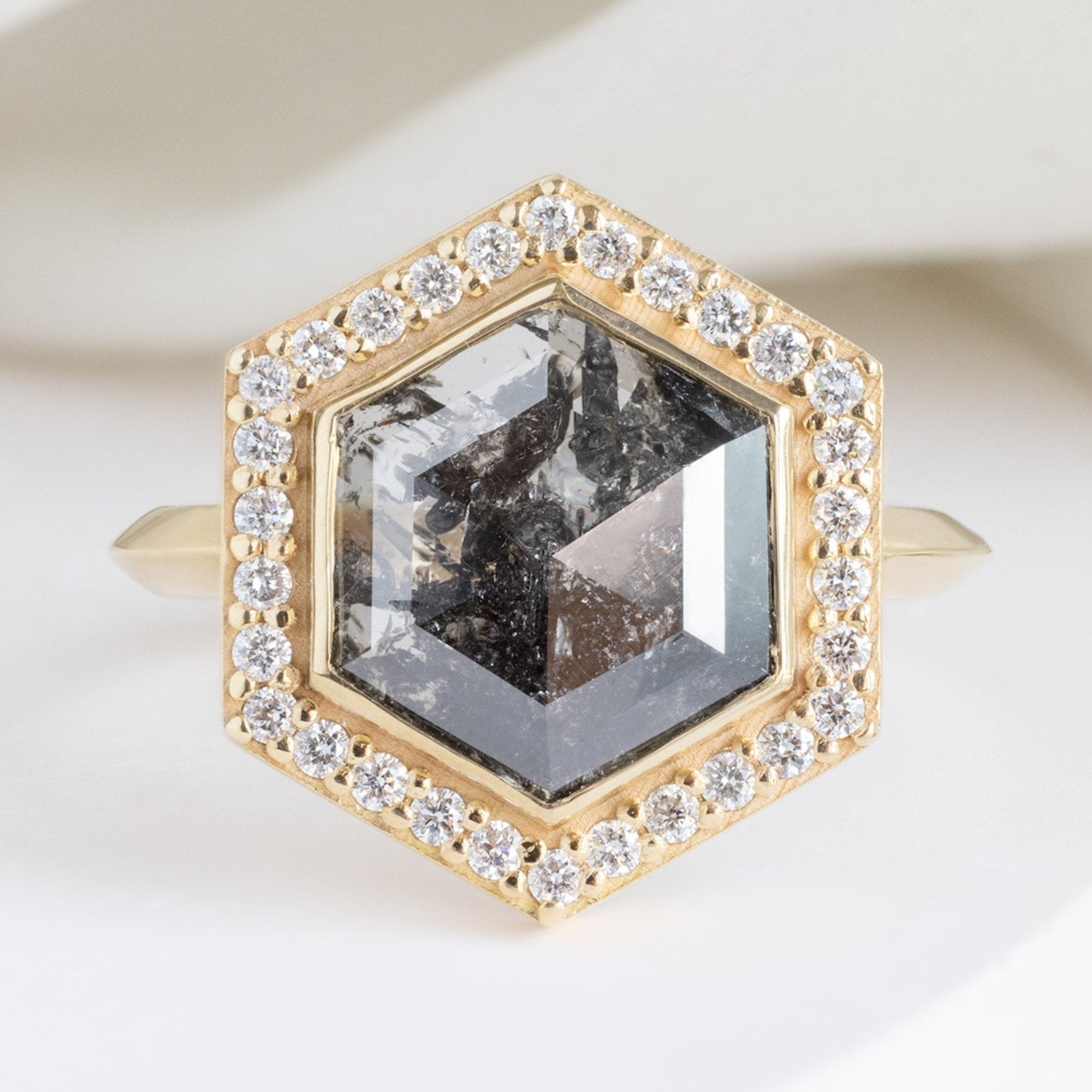 The Dahlia Luxe with a 2.68ct Salt and Pepper Hexagon Diamond in 18K Yellow Gold on White Marble