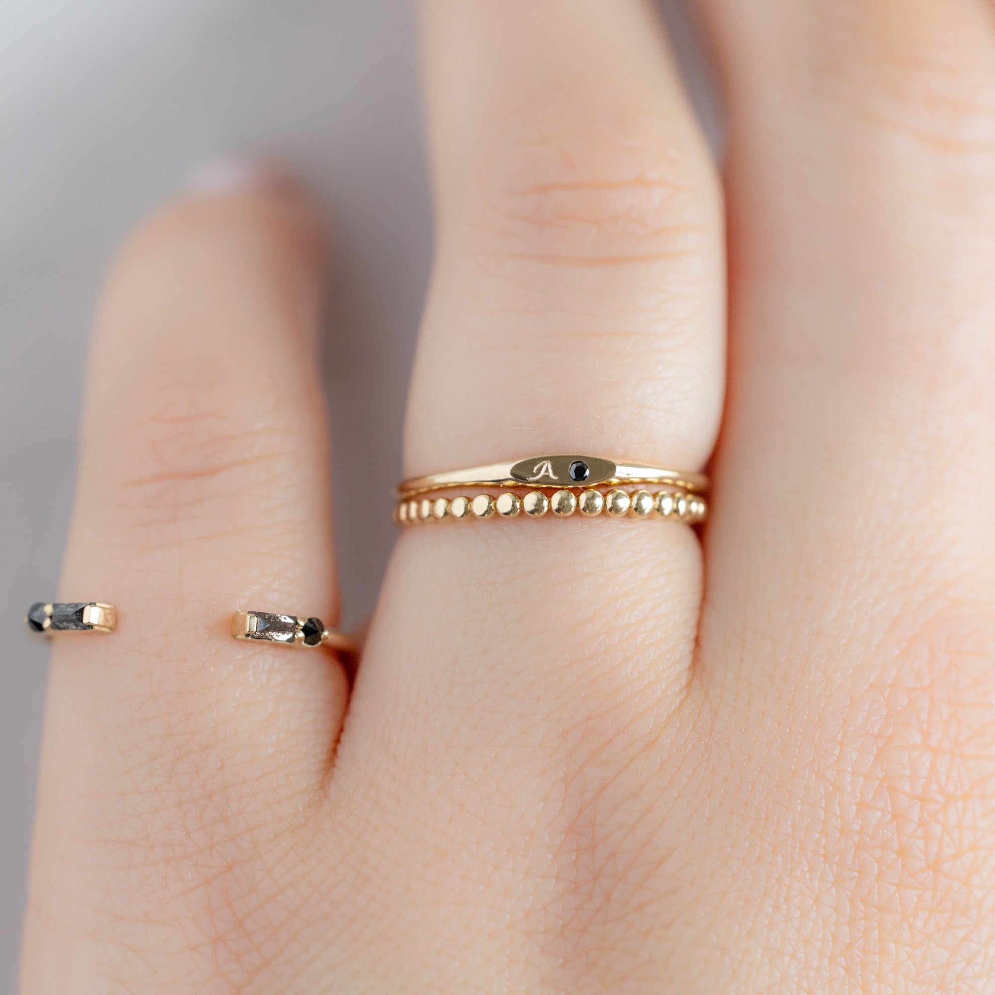 buy:the-luxe-open-cuff-black-baguette-diamond-stacking-band-yellow-rose-or-white-gold,the-teensy-black-diamond-signet-ring-yellow-gold,the-gold-beaded-stacking-ring-14k-yellow-gold