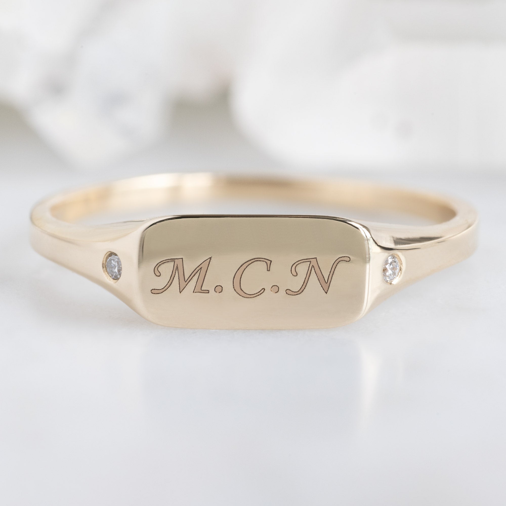 The Monogram Signet Ring in 10K Yellow Gold on White Marble