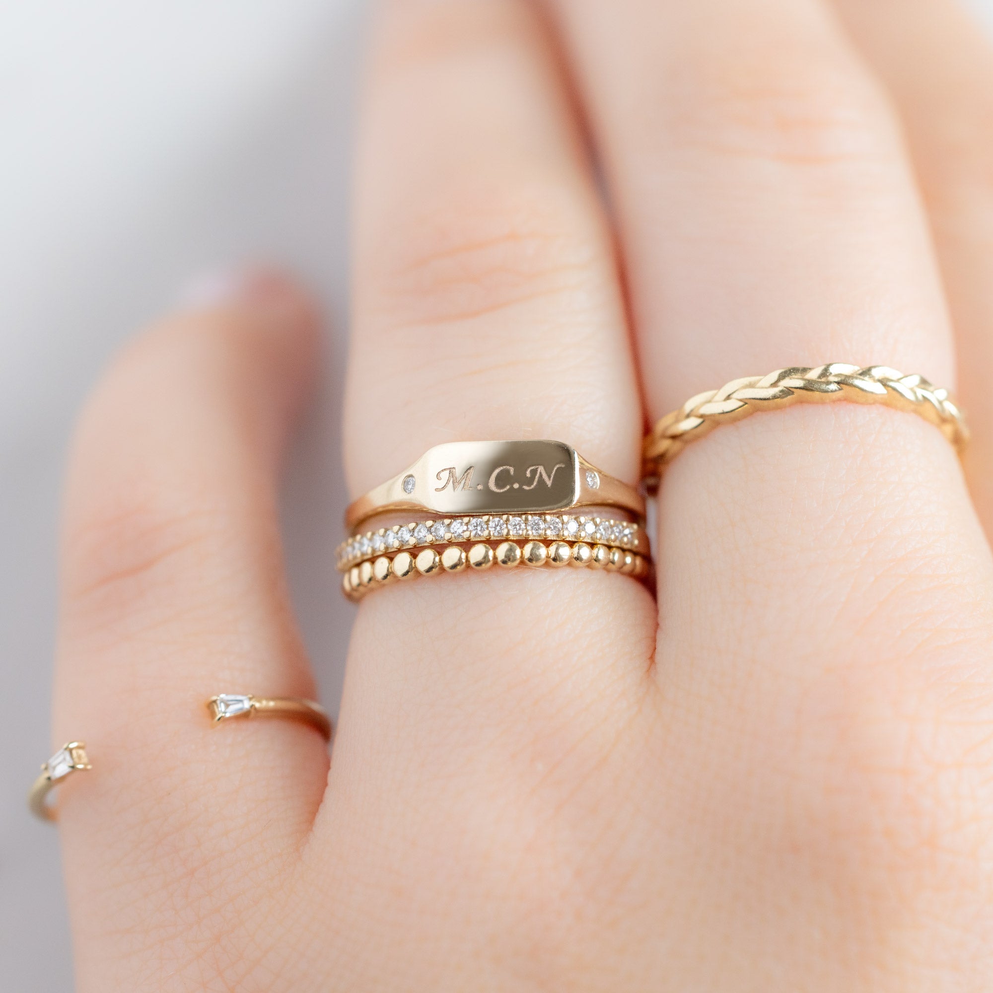 buy:open-cuff-baguette-white-diamond-stacking-band-14k-or-18k-yellow-gold,the-monogram-signet-ring-yellow-gold,the-white-diamond-pave-wedding-band-14k-or-18k-yellow-gold,the-gold-beaded-stacking-ring-14k-yellow-gold,the-gold-braided-stacking-ring-14k-rose-gold