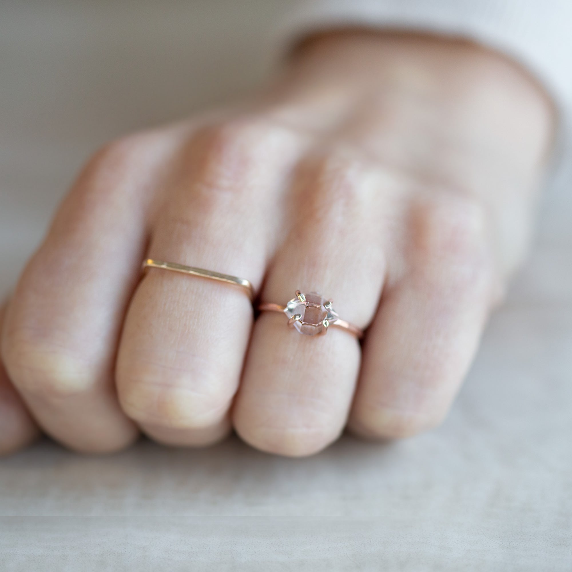 The Herkimer Diamond Ring | Rose Gold Filled. Displayed on model's left hand ring finger alongside another ring on middle finger.