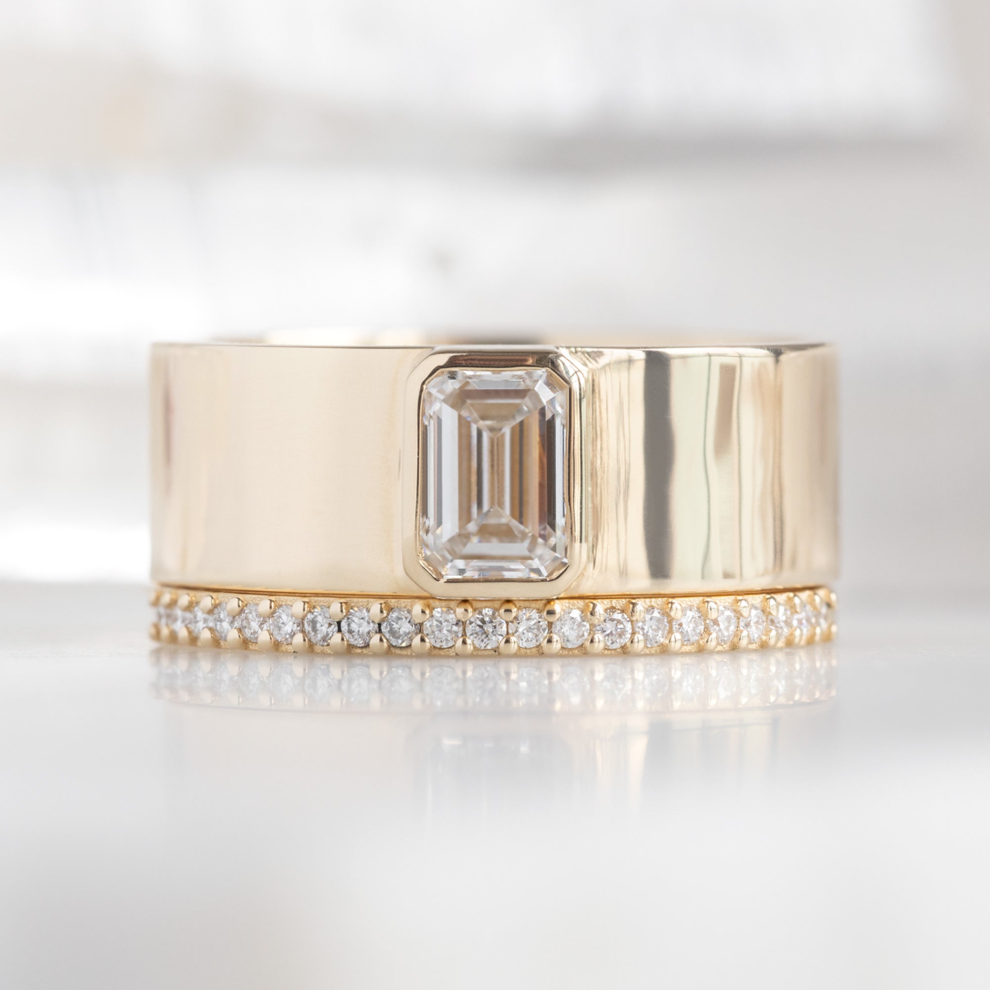 The White Diamond Pavé Wedding Band in 14K Yellow Gold Stacked with a Cigar Band Engagement Ring