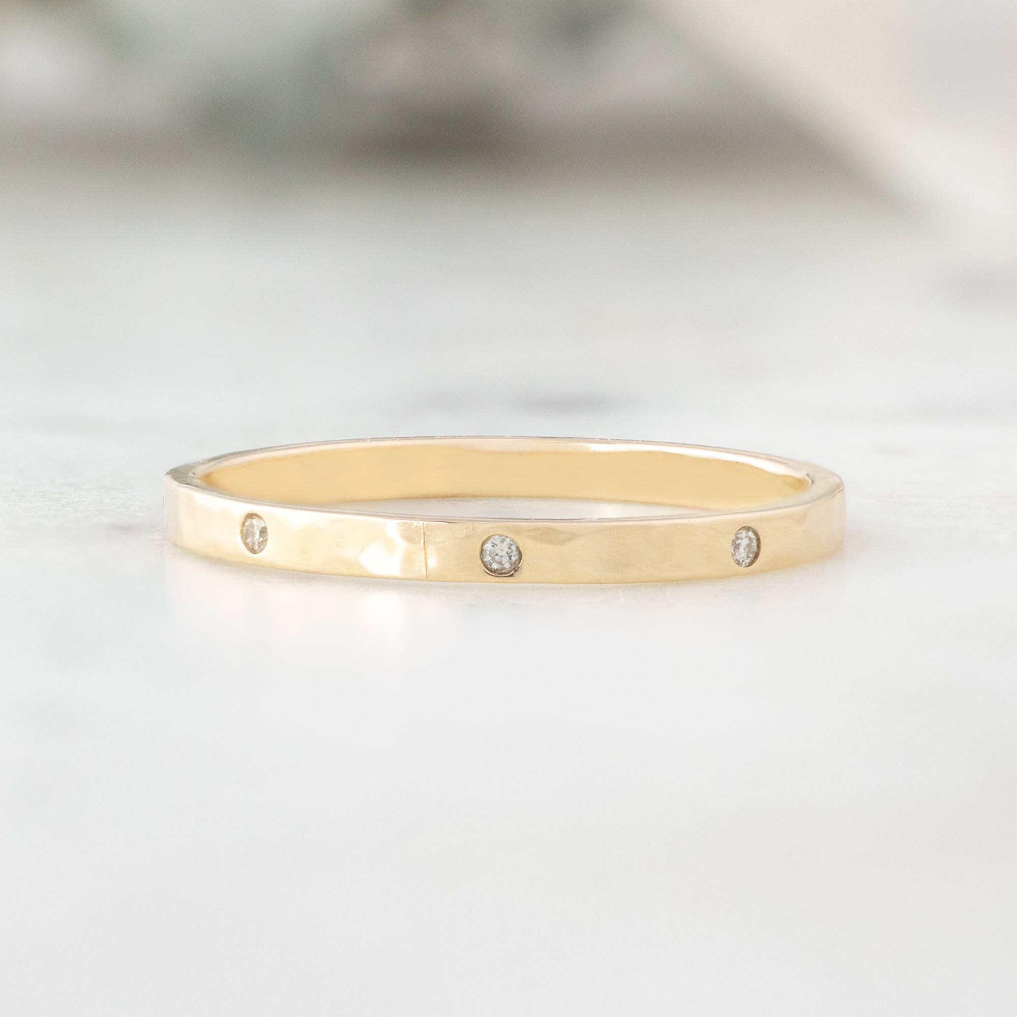 Salt and Pepper Diamond Eternity Band in 14K Yellow Gold on White Marble