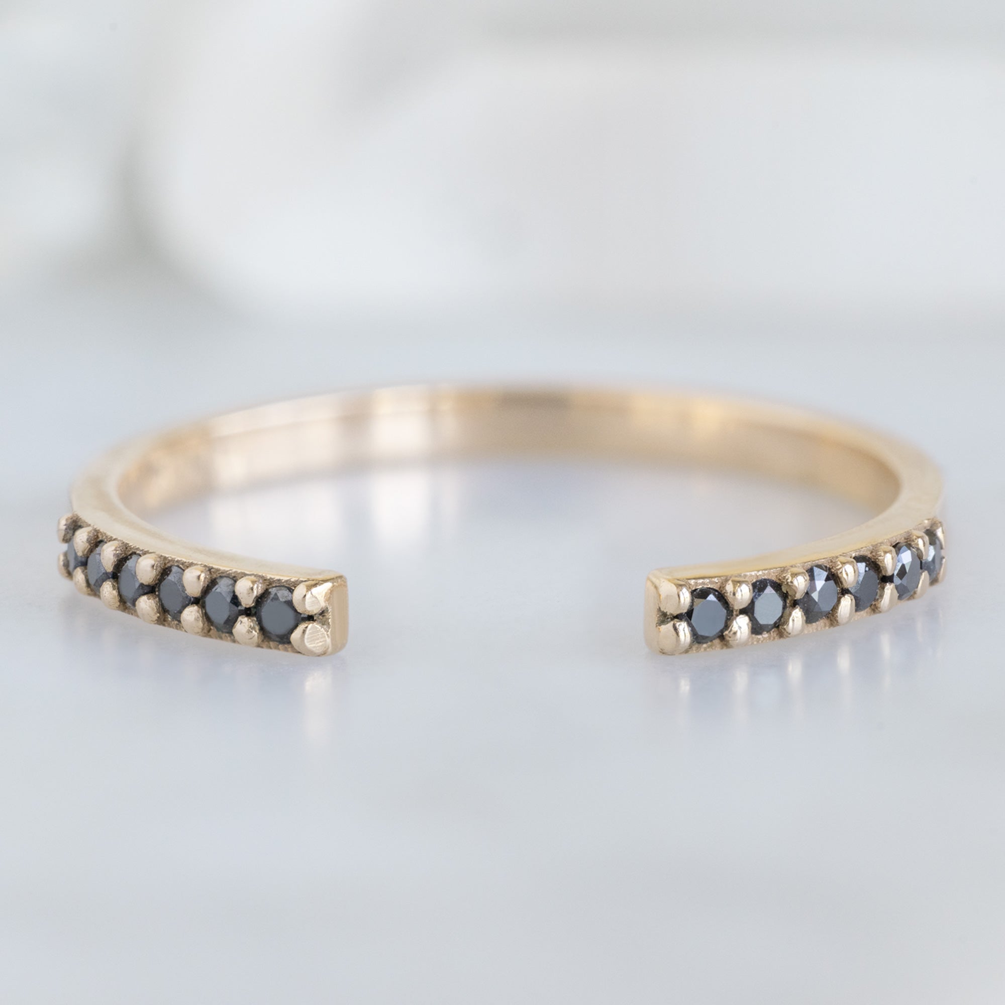 Open Cuff Black Diamond Pavé Stacking Band in 14K Yellow Gold on White Marble