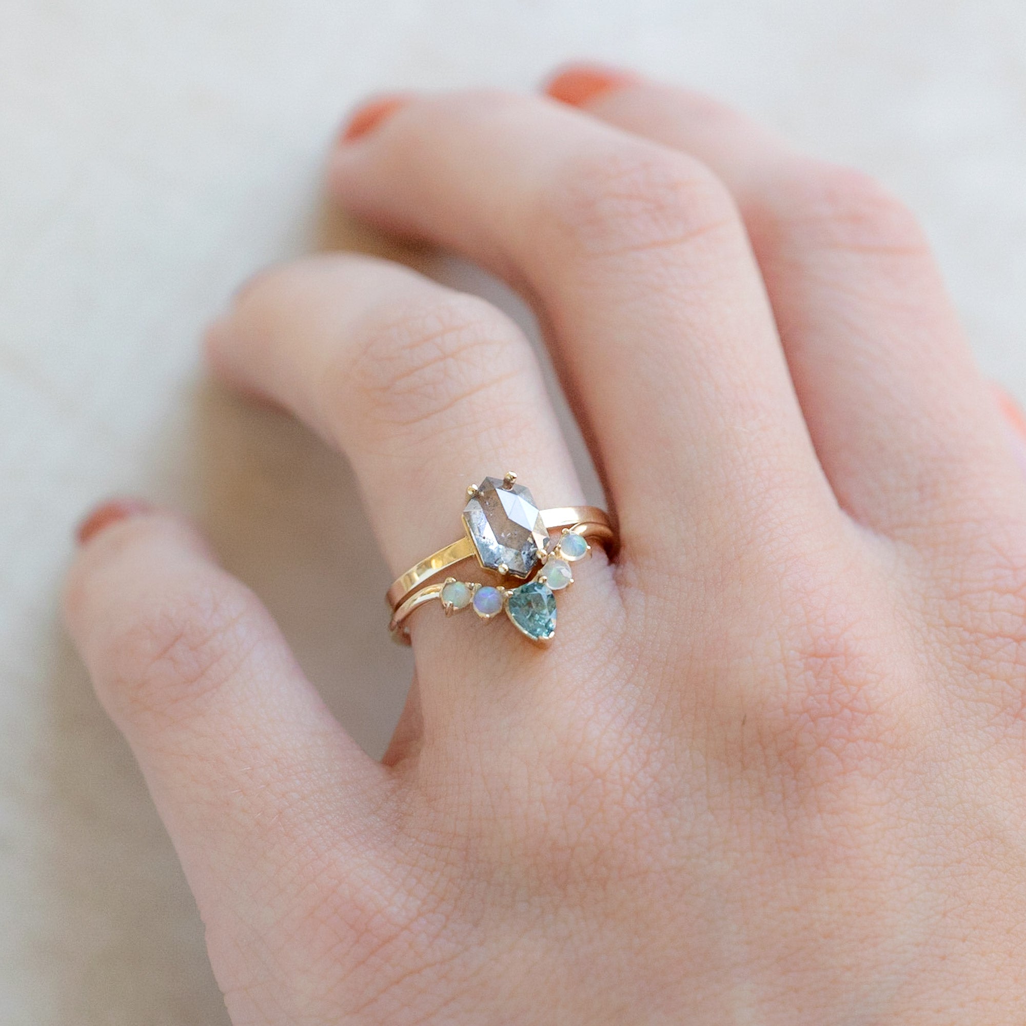 One of a Kind Montana Sapphire + Opal Sunburst Stacking Band in Yellow Gold  Stacked with Diamond Engagement Ring on Model