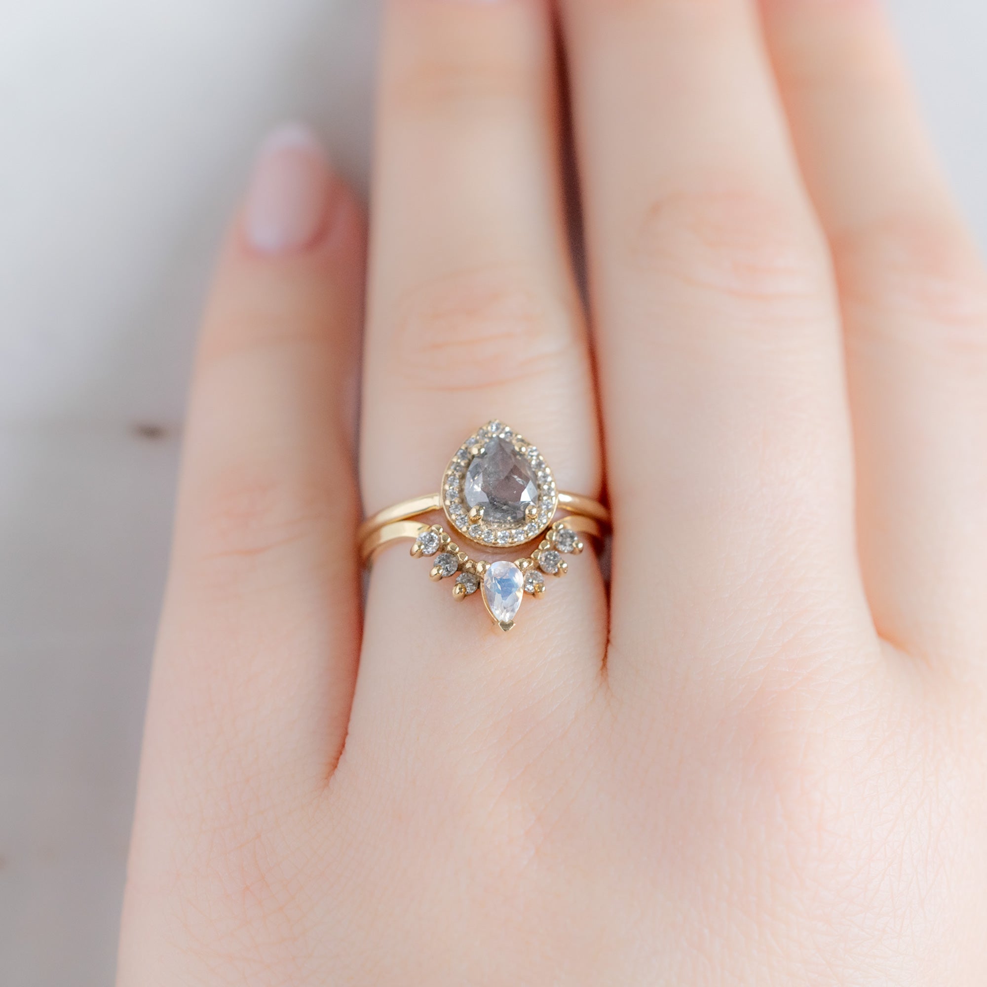 Moonstone and Salt and Pepper Diamond Sunburst Stacking Band in 14K Yellow Gold Stacked with Pear Diamond Engagement Ring on Model
