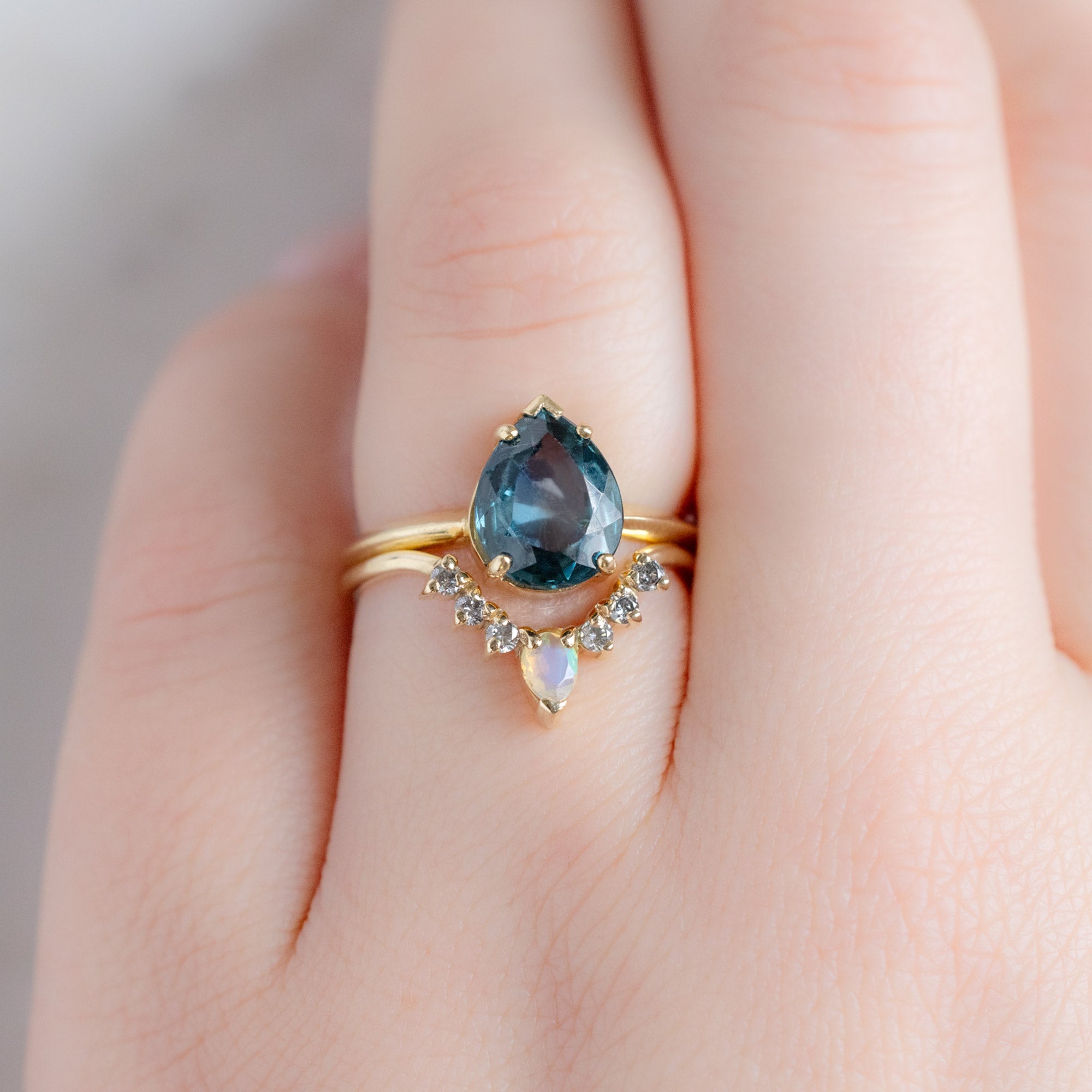 One of a Kind Opal and Salt and Pepper Diamond Sunburst Stacking Band in 14K Gold Stacked with Blue Sapphire Engagement Ring on Model