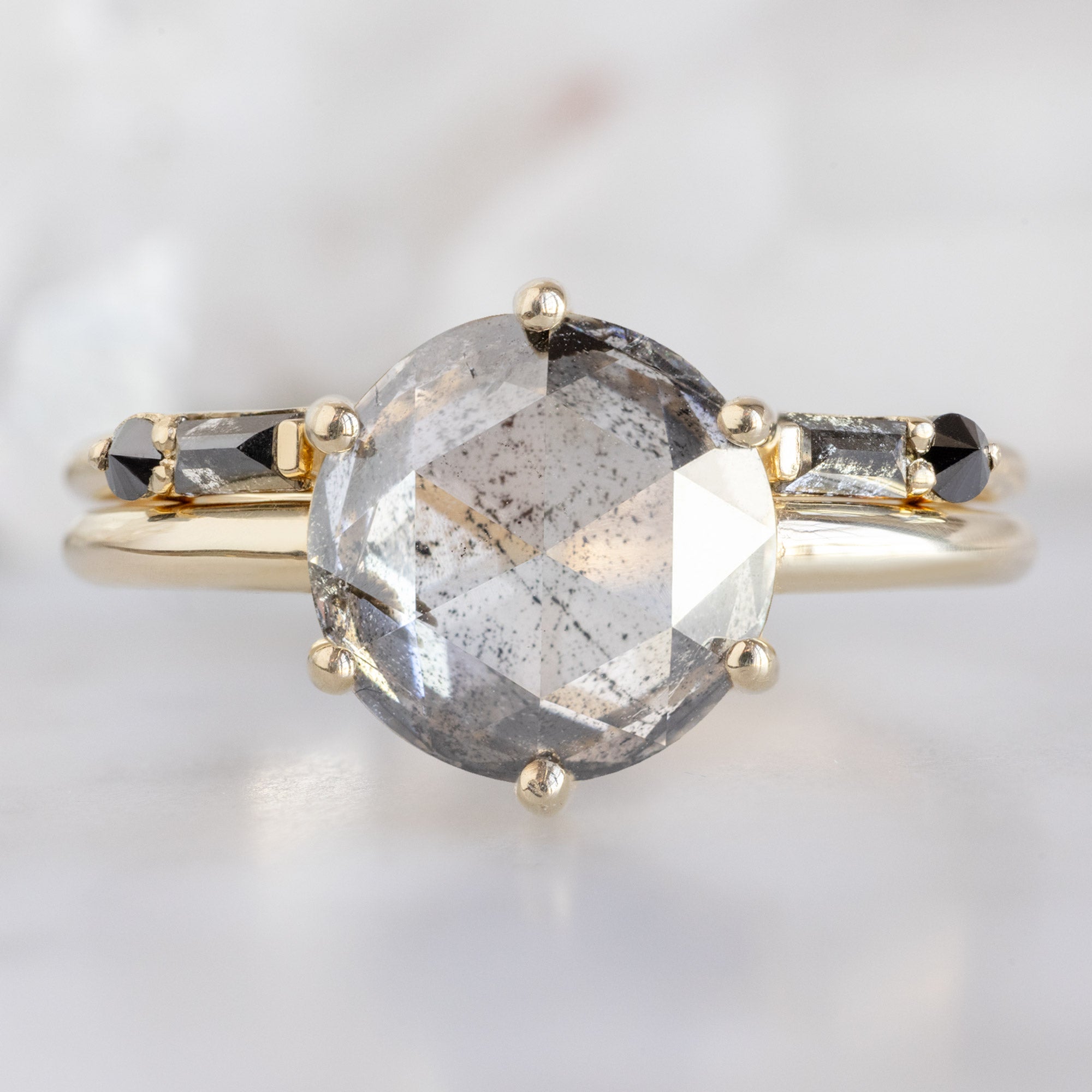 The Luxe Open Cuff Black Baguette Diamond Stacking Band in 14K Yellow Gold stacked with diamond engagement ring