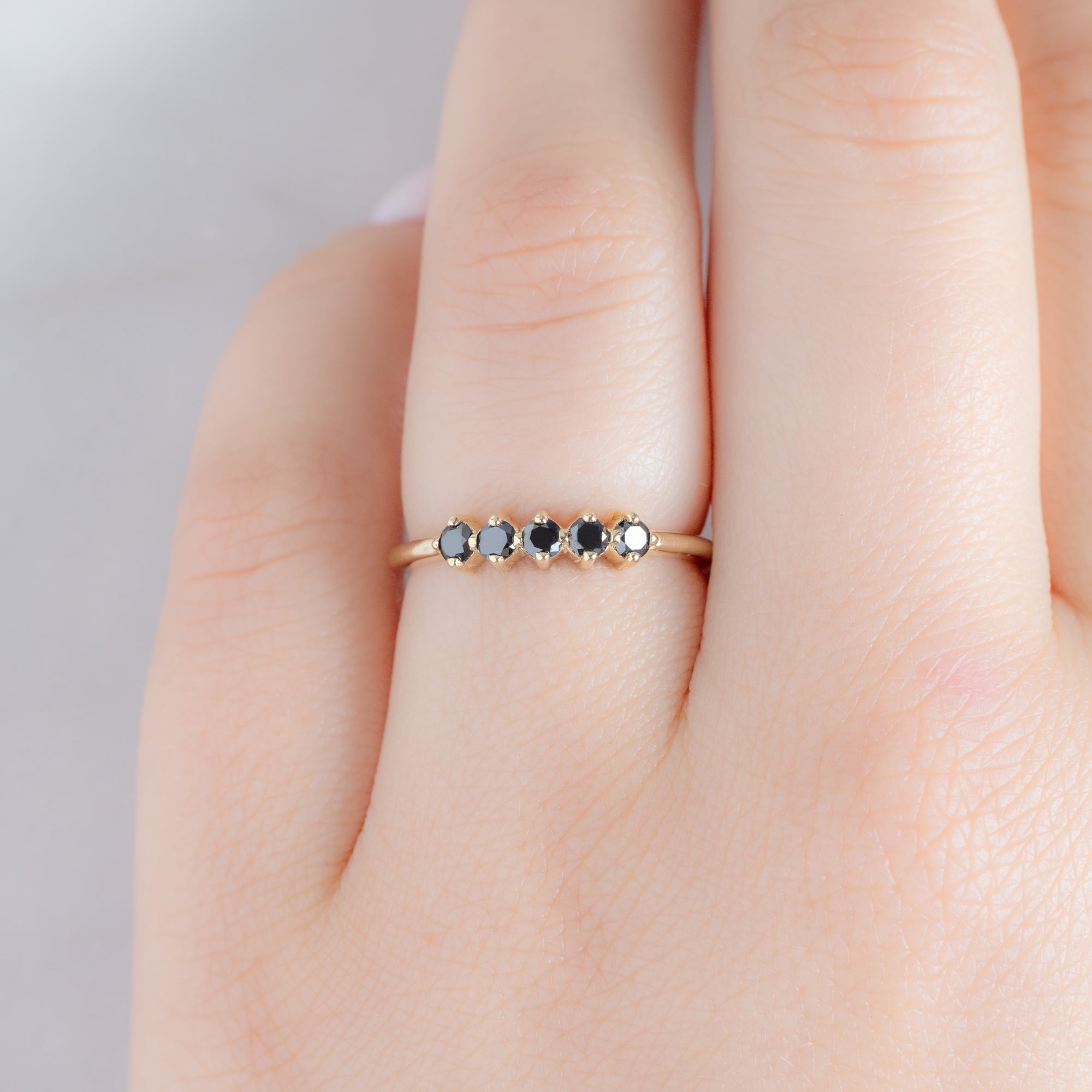 The Sequent Black Diamond Wedding Band in 14K Yellow Gold on Model