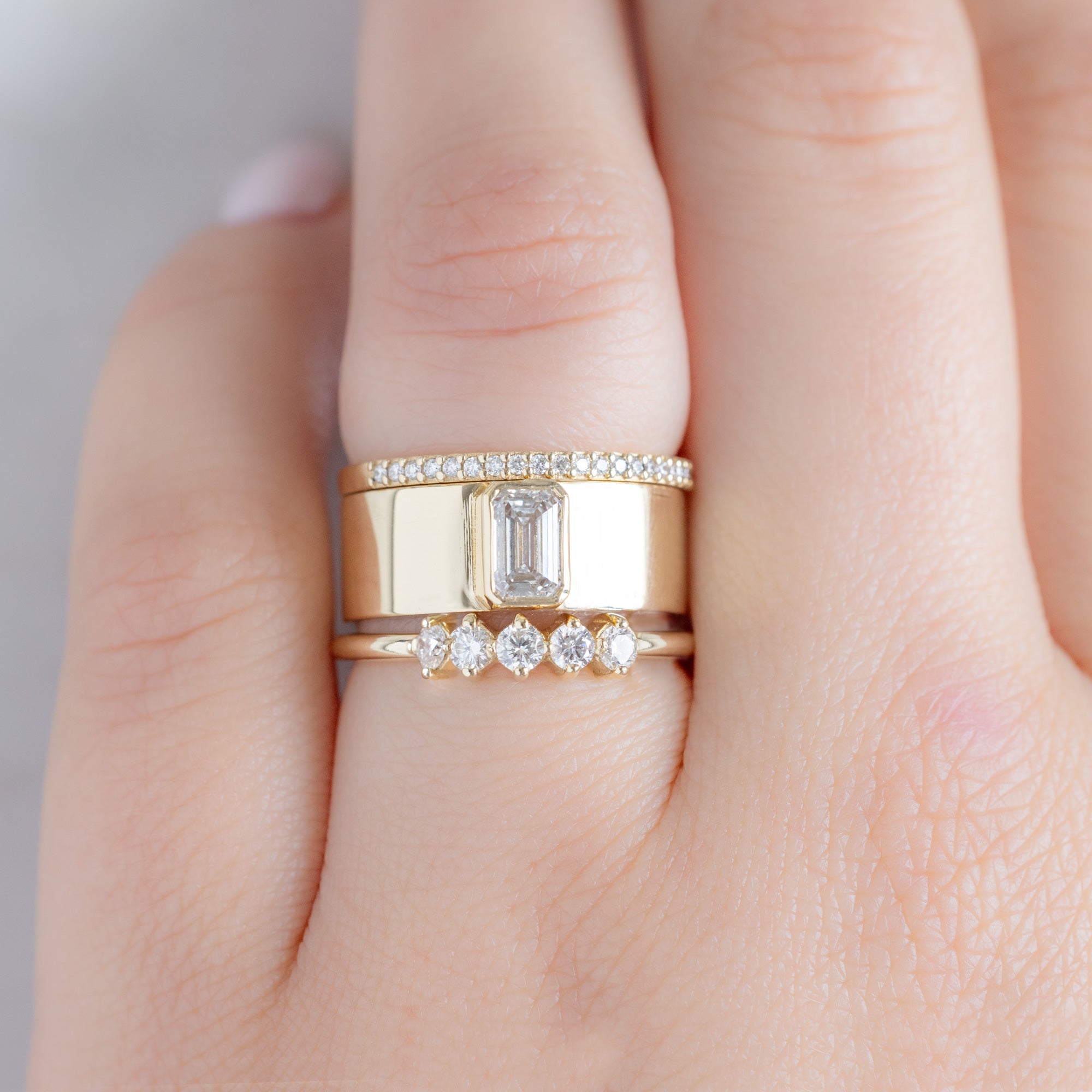 The Sequent White Diamond Wedding Band in 14K Yellow Gold Stacked with White Diamond Cigar Engagement Ring on Model
