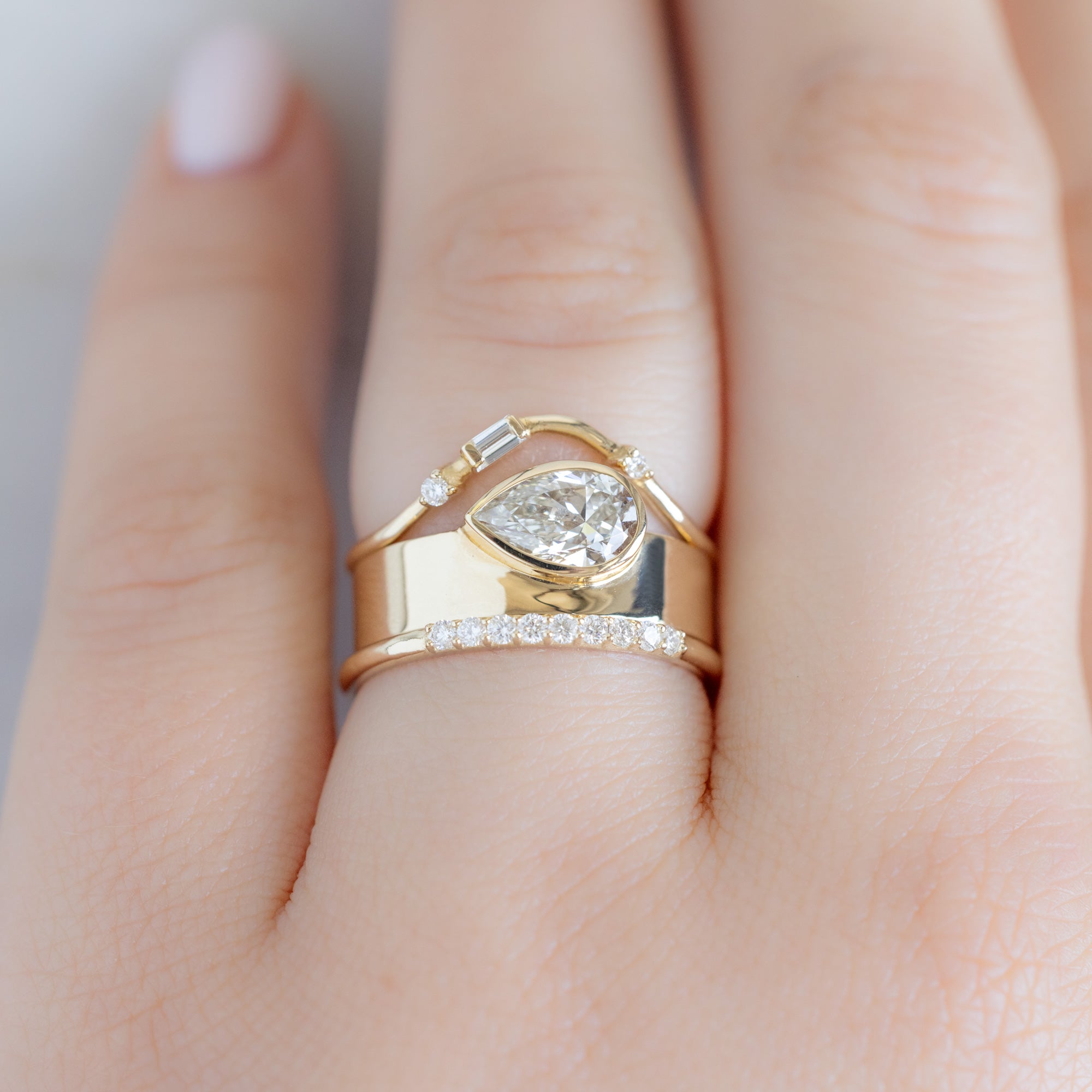 The Luxe White Diamond Pavé Wedding Band in 14k Yellow Gold Stacked with Cigar Band Diamond Engagement Ring on Model