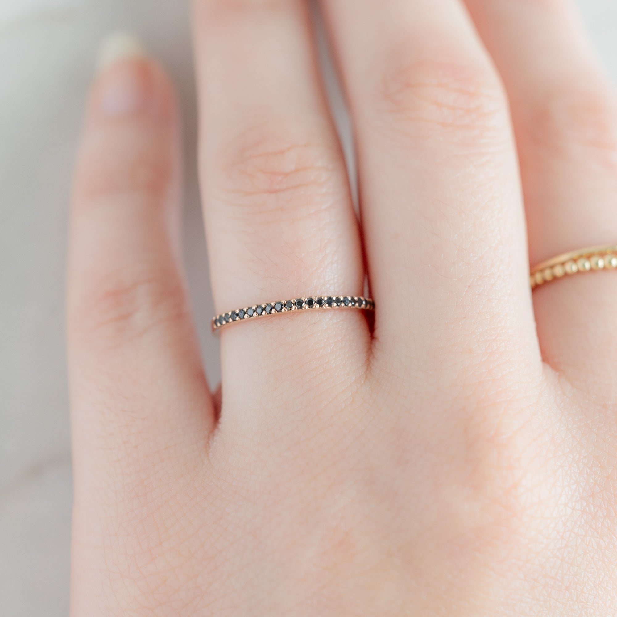The Black Diamond Pavé Wedding Band in 14K Yellow Gold on Model