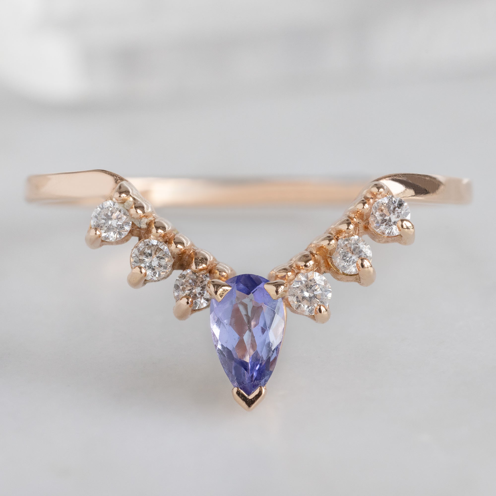 One of a Kind Tanzanite and White Diamond Sunburst Stacking Band in 14K Rose Gold on White Marble