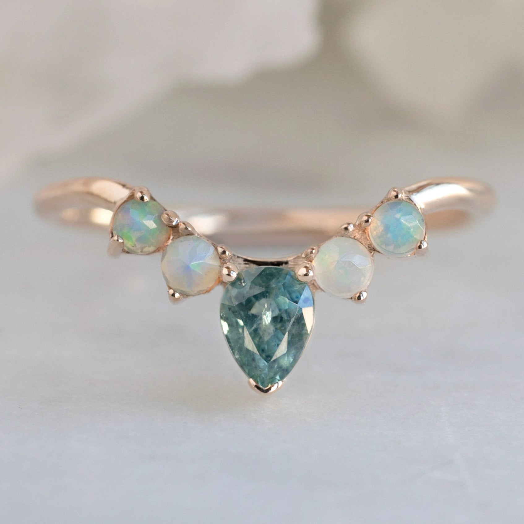 One of a Kind Montana Sapphire + Opal Sunburst Stacking Band in Rose Gold on White Marble Surface