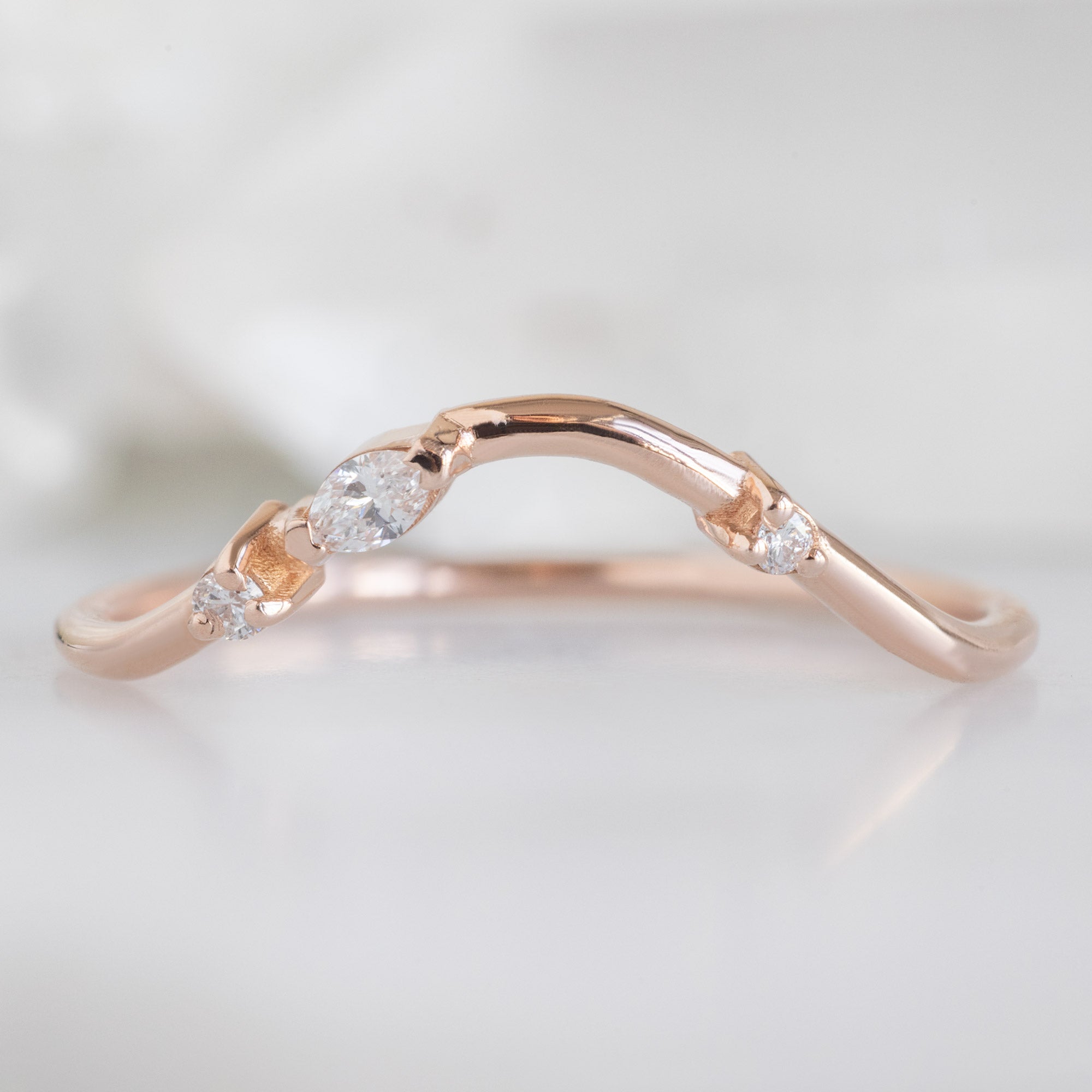 Asymmetrical Marquise Diamond Arc Stacking Band in 14K Rose Gold on White Marble