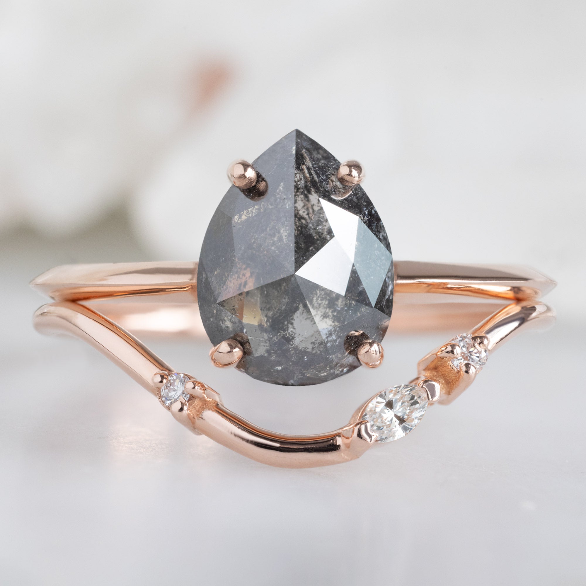Asymmetrical Marquise Diamond Arc Stacking Band in 14K Rose Gold Stacked with a Black Pear Shaped Diamond Engagement Ring
