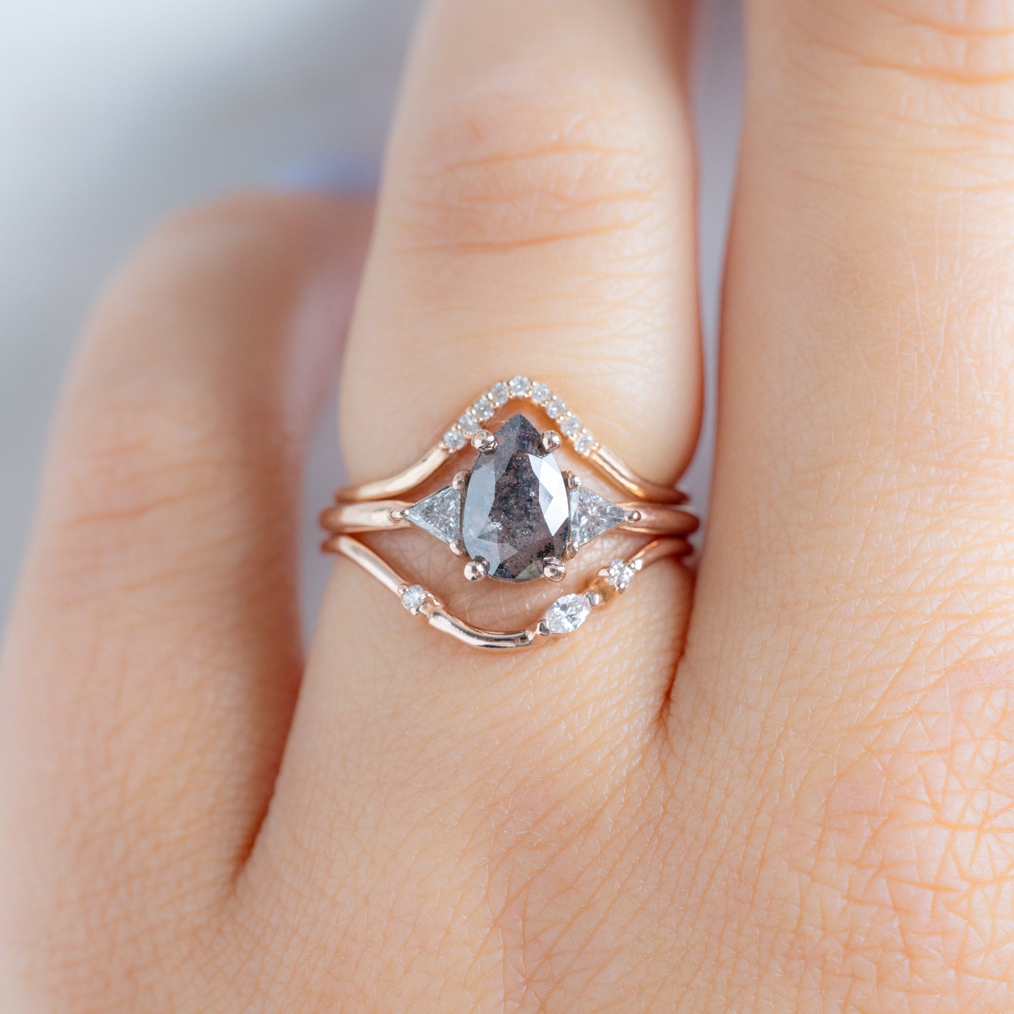 Asymmetrical Marquise Diamond Arc Stacking Band in 14K Rose Gold Stacked with Pear Shaped Diamond Engagement Ring on Model