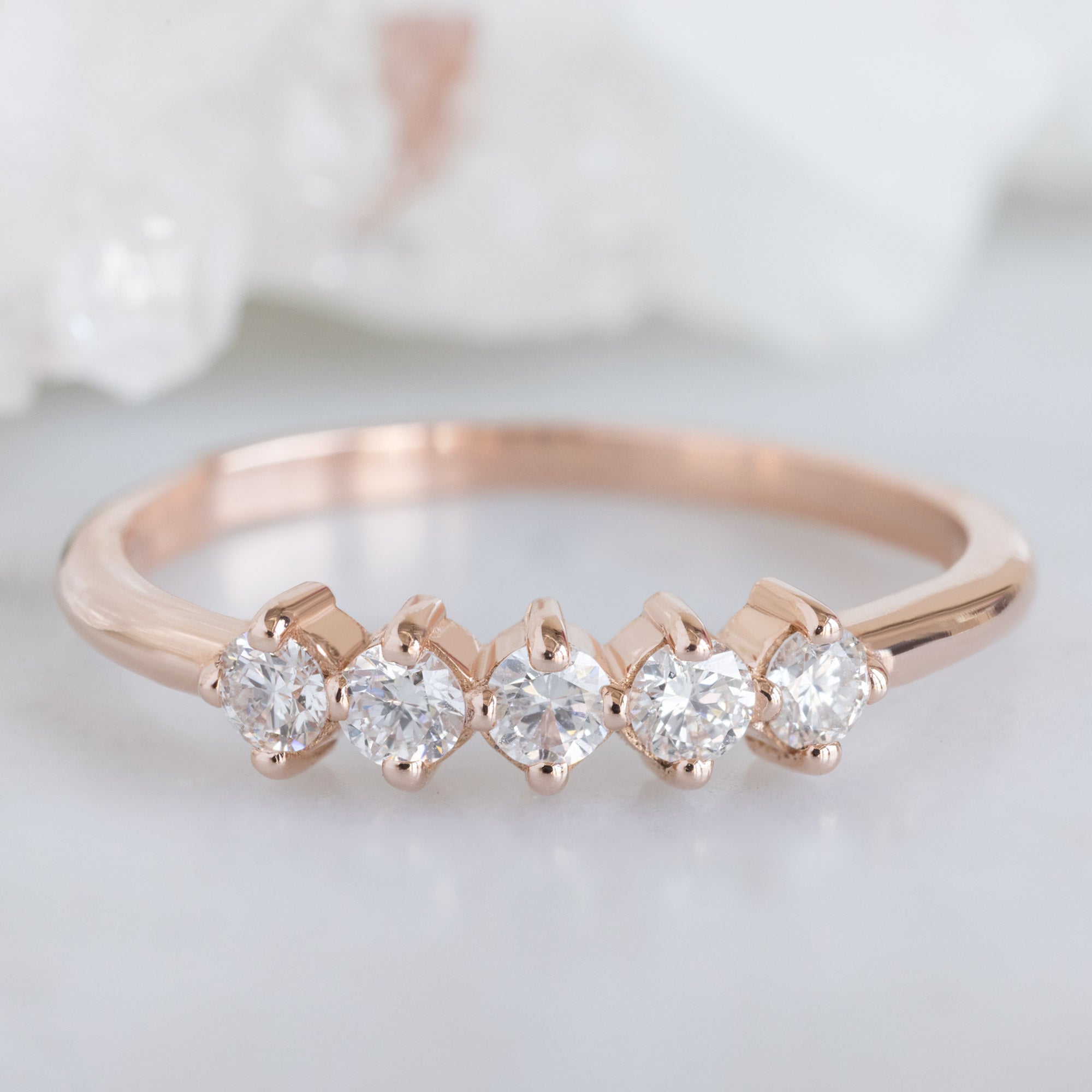 The Sequent White Diamond Wedding Band in 14K Rose Gold on White Marble