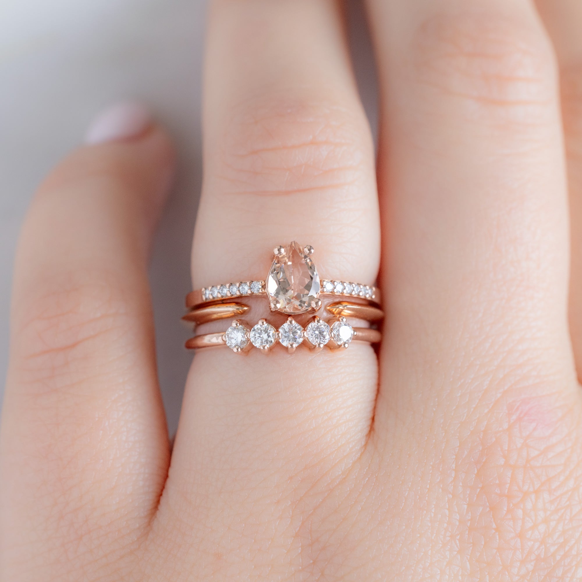 The Sequent White Diamond Wedding Band in 14K Rose Gold Stacked with Pear Morganite Engagement Ring on Model