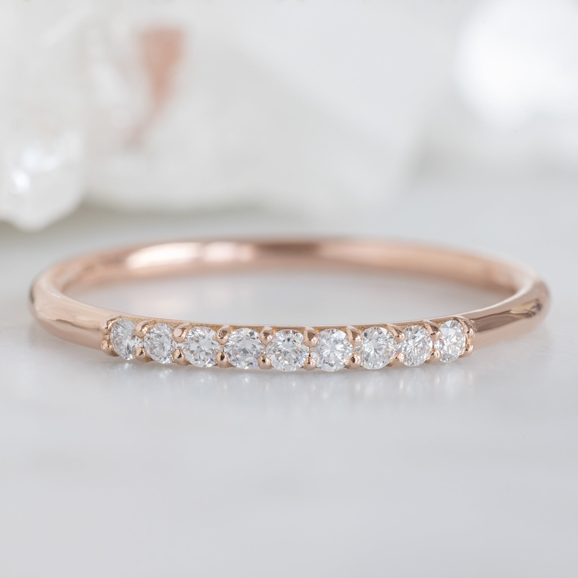The Luxe White Diamond Pavé Wedding Band in 14k Rose Gold on White Marble
