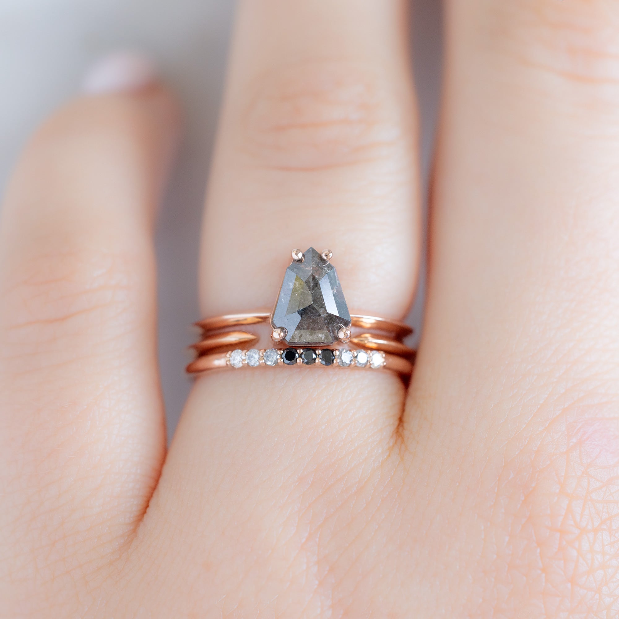 The Luxe Ombré Diamond Pavé Wedding Band in 14K Rose Gold Stacked with Black Geometric Diamond Engagement Ring on Model