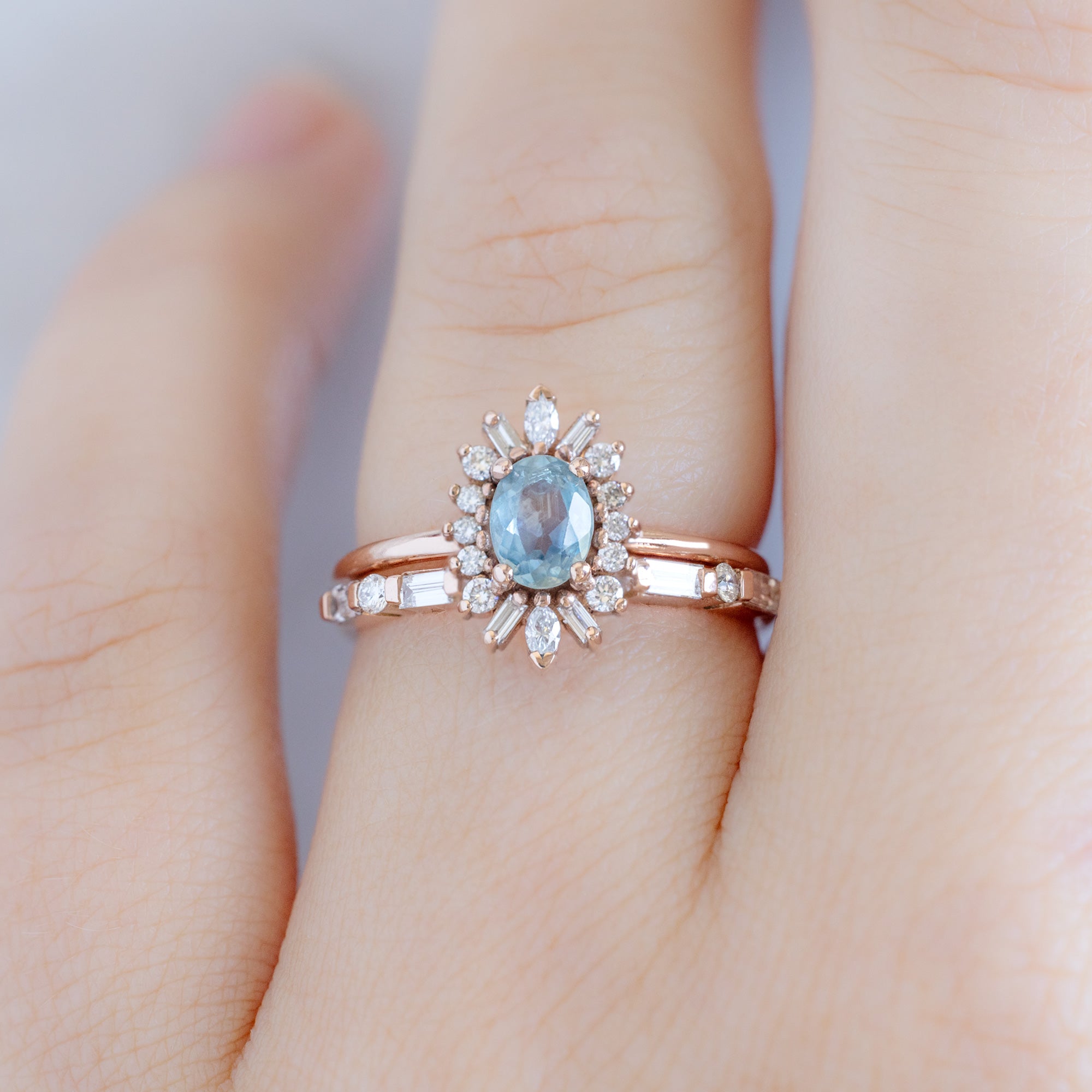 The Luxe Baguette White Diamond Eternity Band in 14K Rose Gold tacked with oval sapphire gemstone engagement ring on model