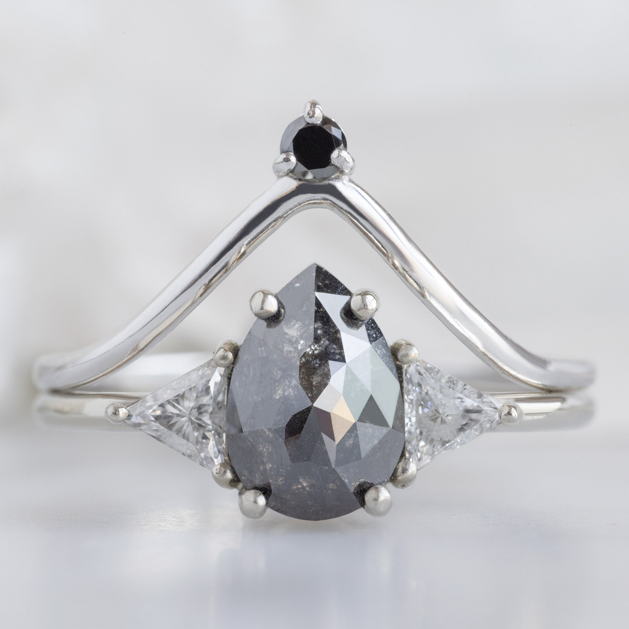 Black Diamond Crown Stacking Band in 14K White Gold Stacked with a Black Pear Diamond Engagement Ring