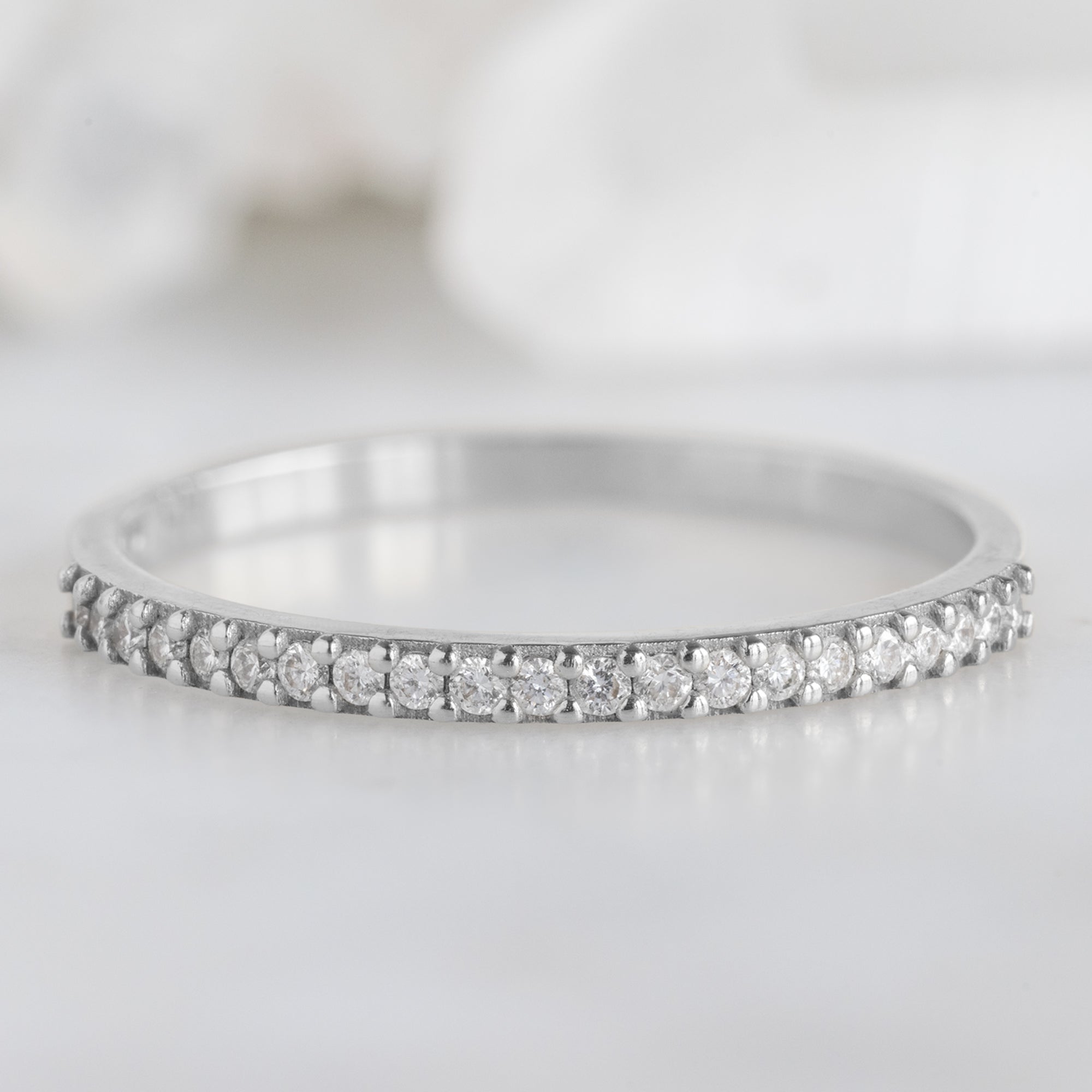 The White Diamond Pavé Wedding Band in 14K White Gold on White Marble Tile