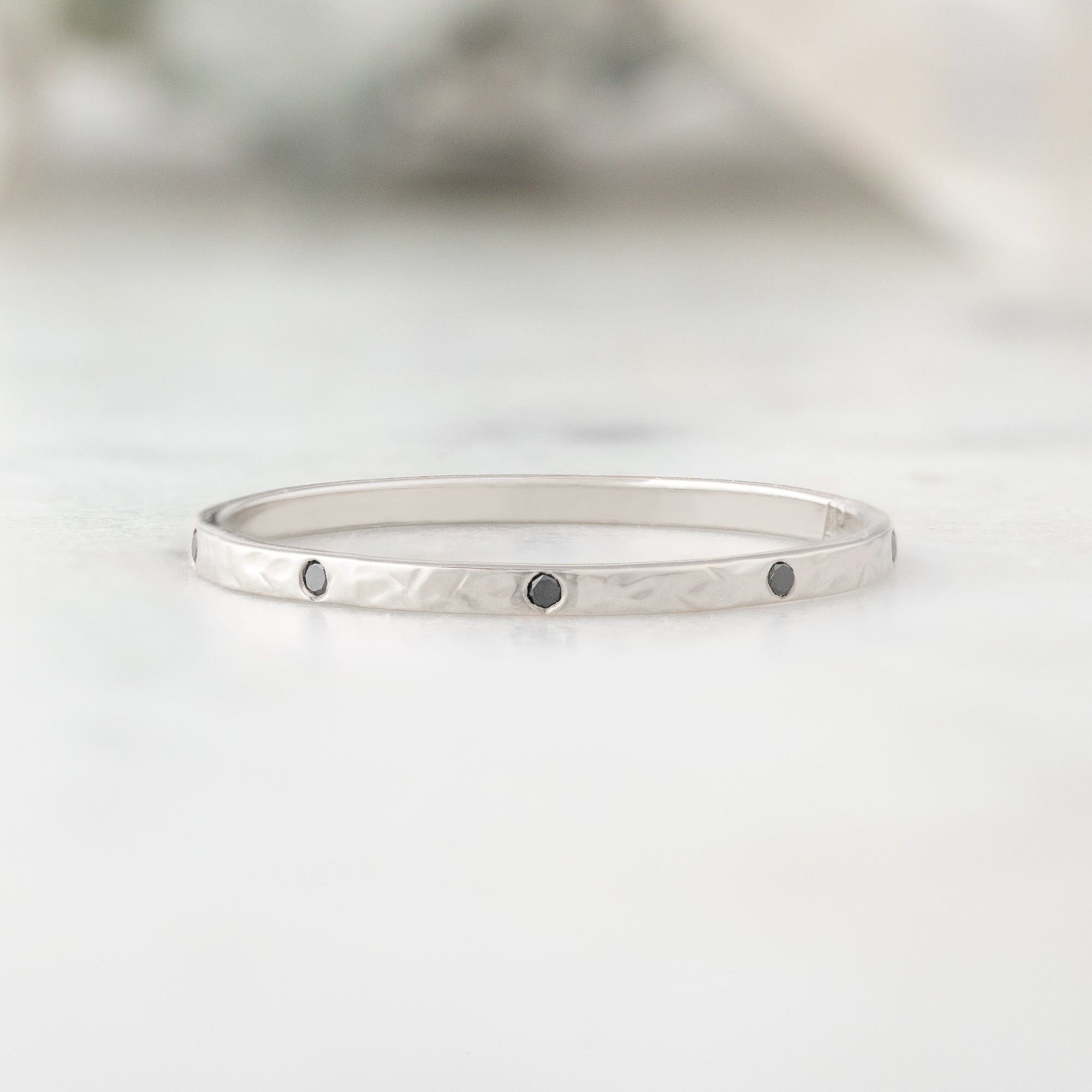 Black Diamond Eternity Band in 14K White Gold on White Marble