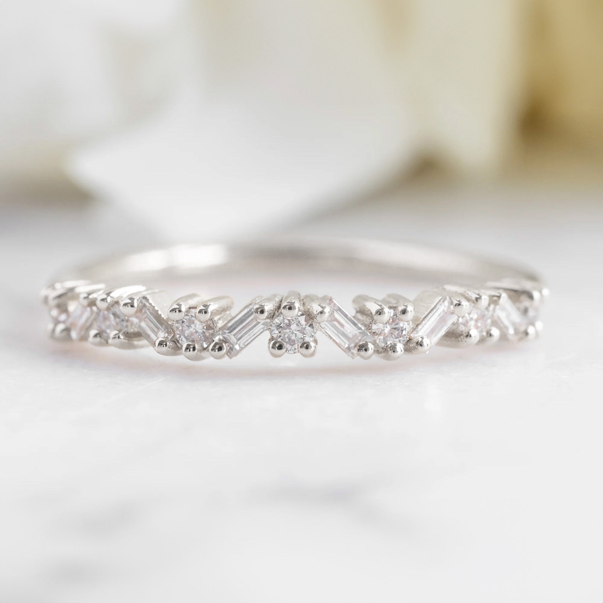 The Baguette Confetti Stacking Ring In 14k White Gold on White Marble Surface