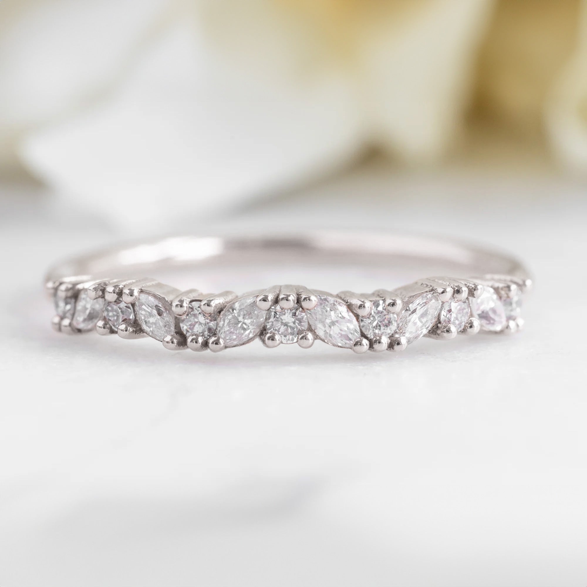 The Marquise Confetti Wedding Band in 14K White Gold on White Marble