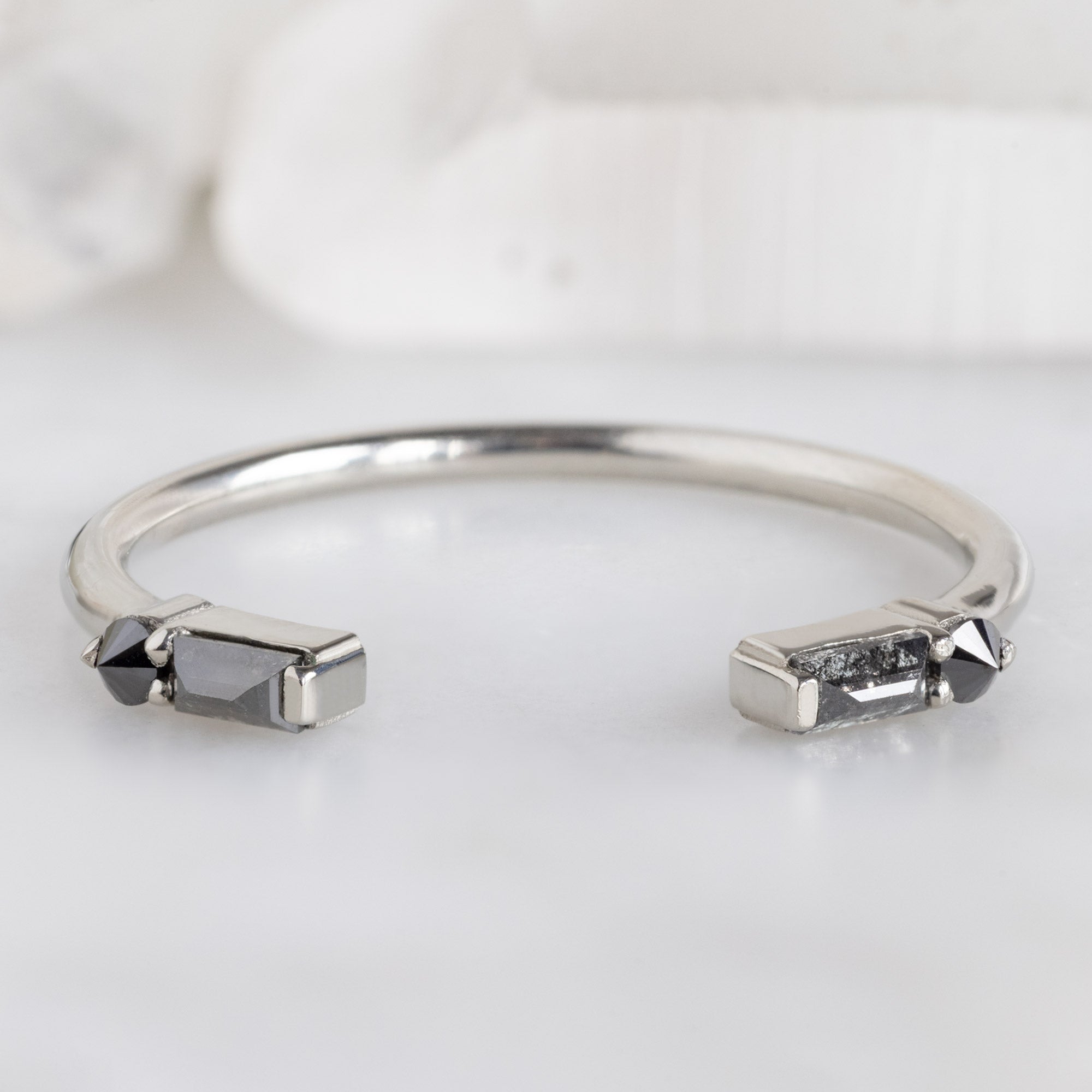 The Luxe Open Cuff Black Baguette Diamond Stacking Band in 14K White Gold on White Marble