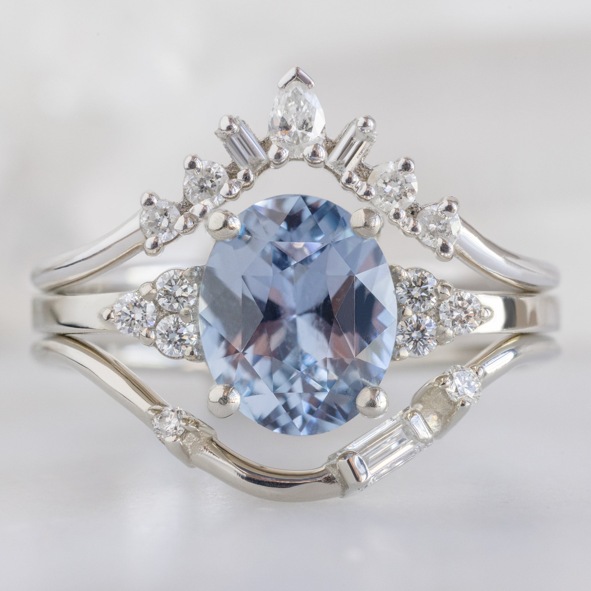 Asymmetrical Baguette Diamond Arc Stacking Band in 14K White Gold Stacked with a Round Blue Sapphire Gemstone Engagement Ring