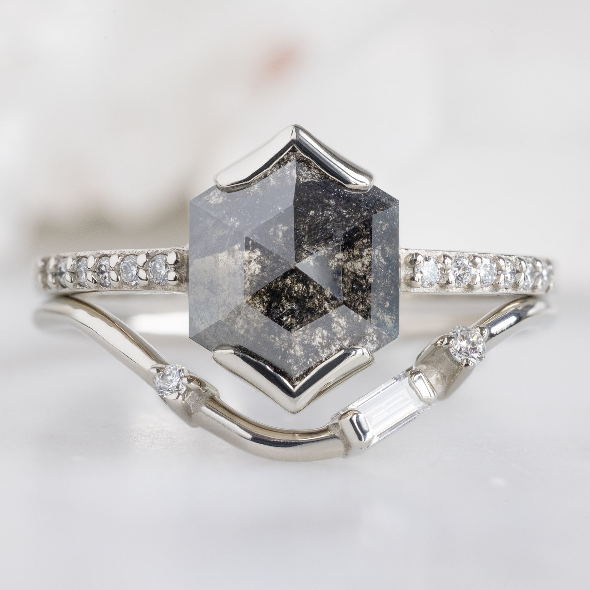 Asymmetrical Baguette Diamond Arc Stacking Band in 14K White Gold Stacked with a Black Hexagonal Diamond Engagement Ring
