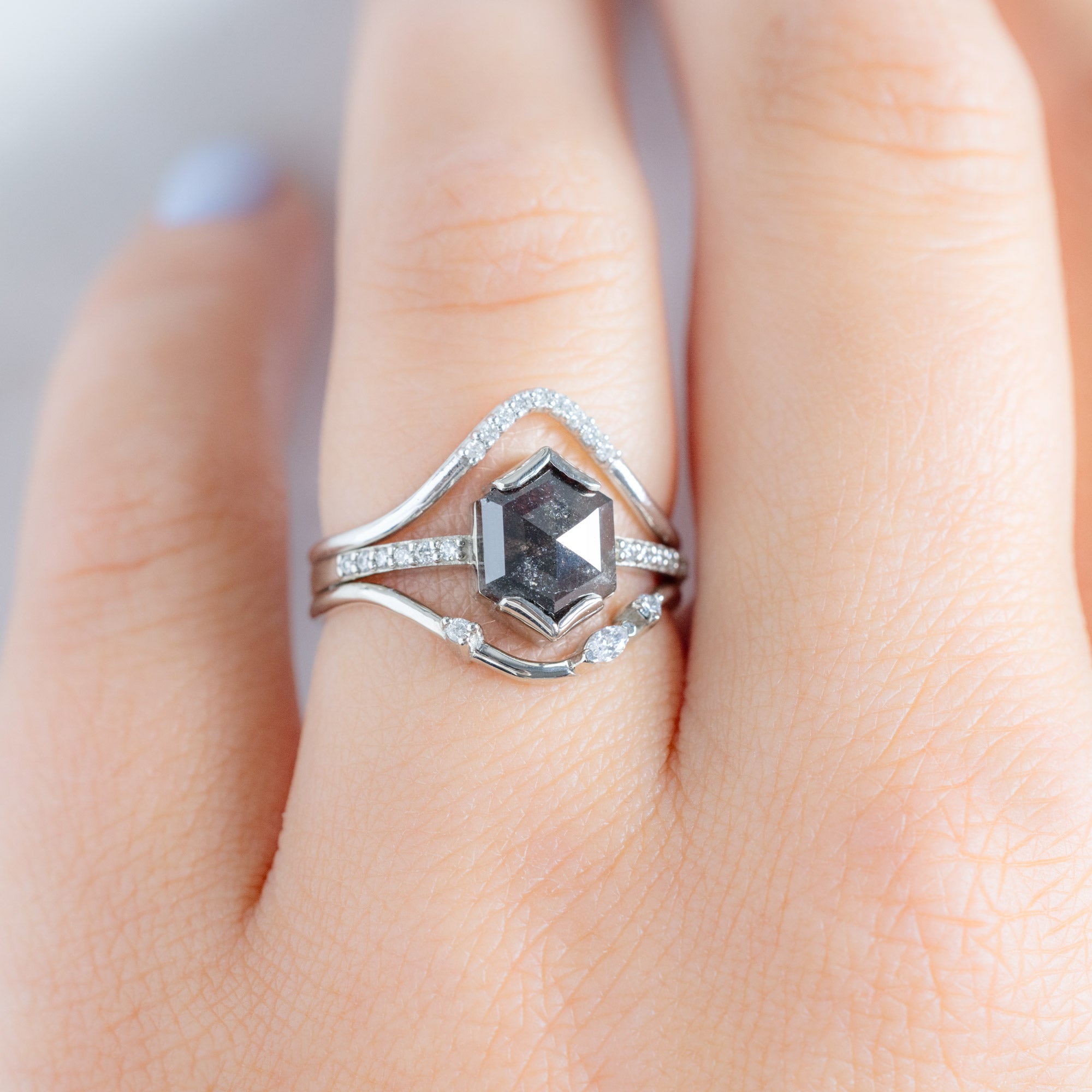 Asymmetrical Marquise Diamond Arc Stacking Band in 14K White Gold Stacked with a Black Hexagonal Diamond Engagement Ring on Model