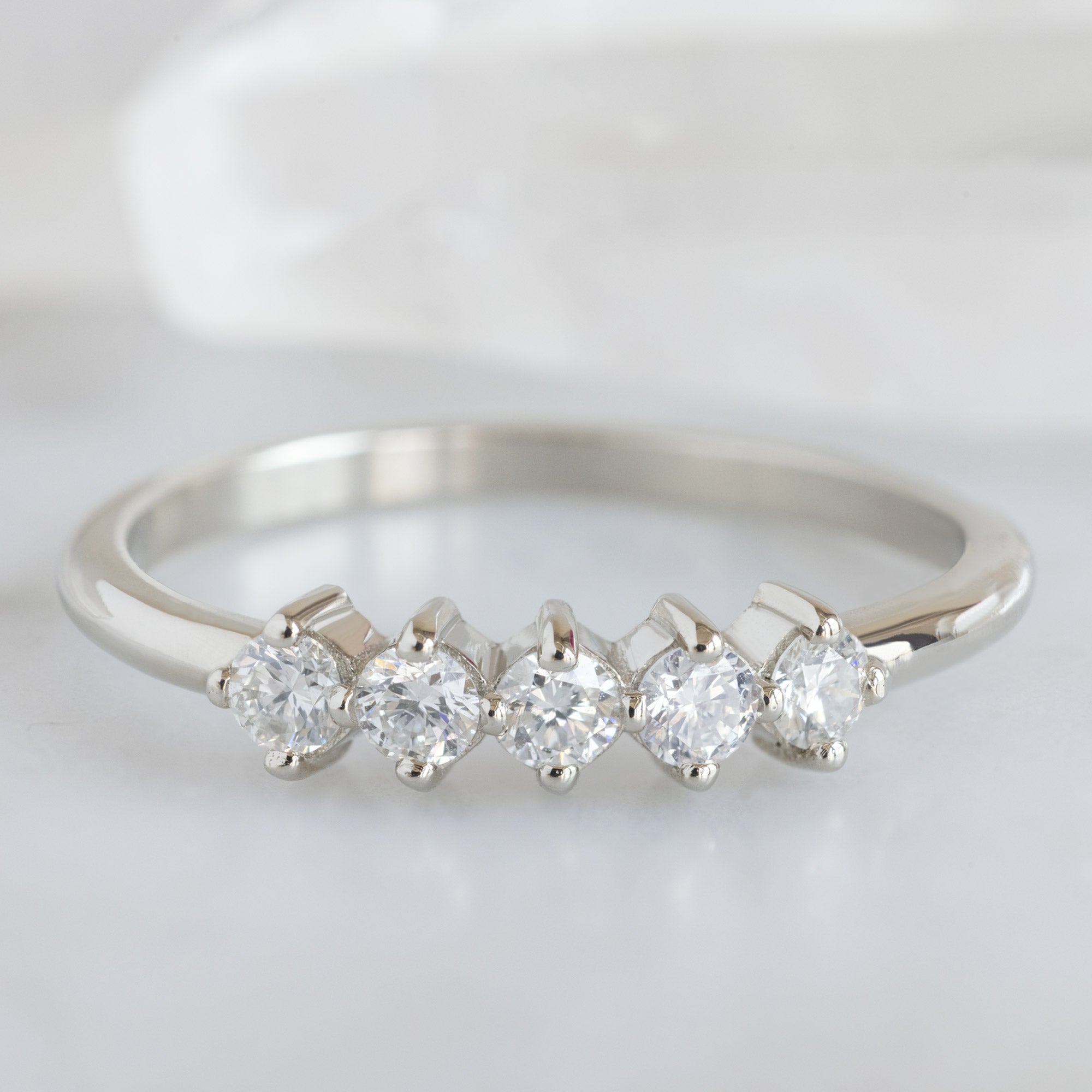 The Sequent White Diamond Wedding Band in 14K White Gold on White Marble