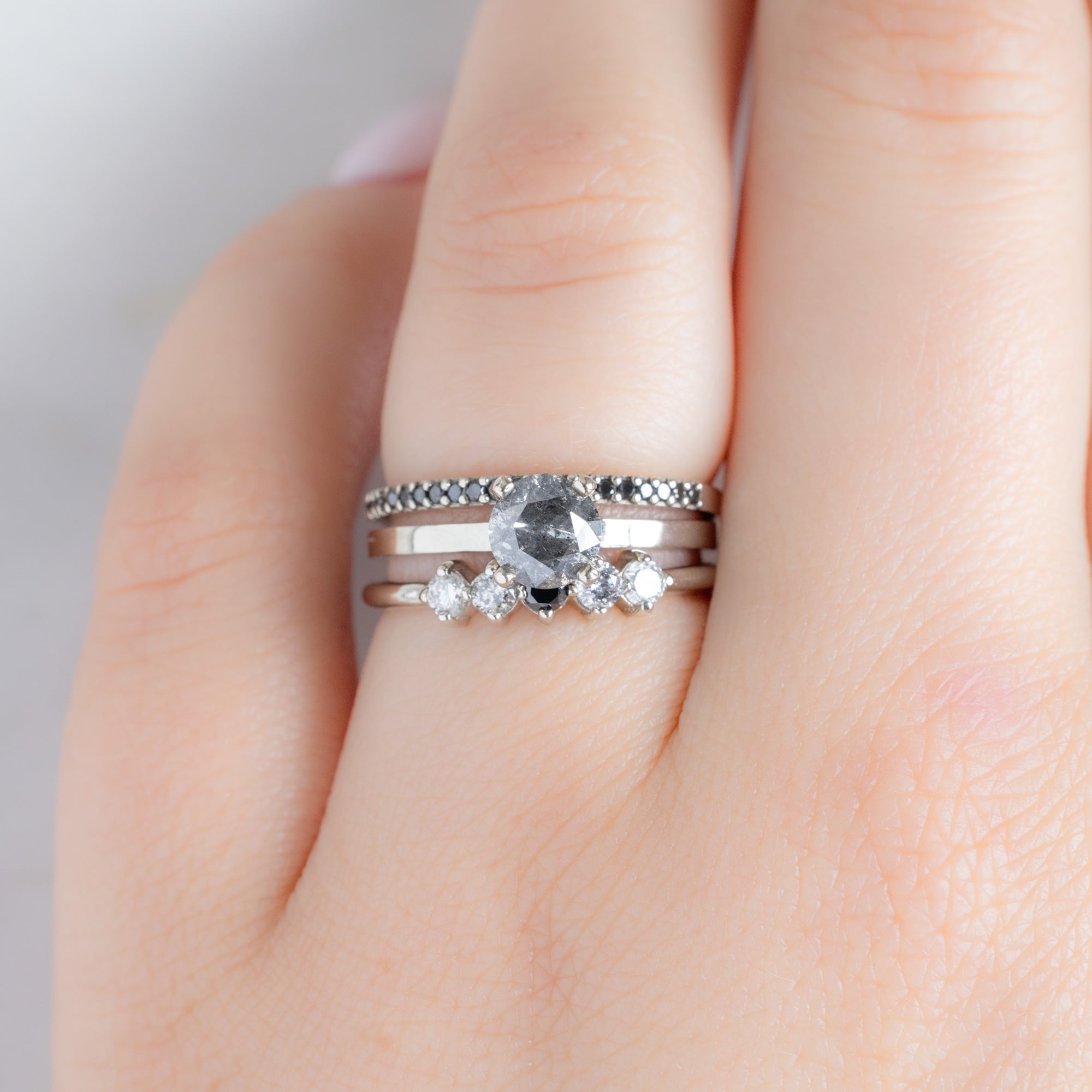 The Sequent Ombré Diamond Wedding Band in 14K White Gold Stacked with Round Salt and Pepper Diamond Engagement Ring on Model