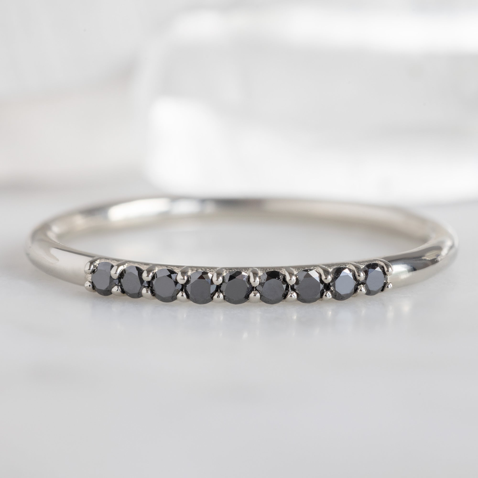 The Luxe Black Diamond Pavé Wedding Band in 14K White Gold on White Marble