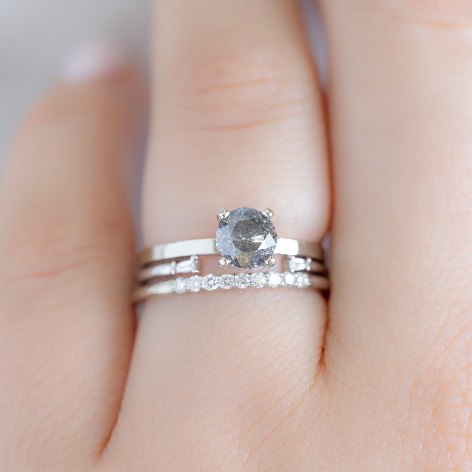 The Luxe White Diamond Pavé Wedding Band in 14K White Gold Stacked with Salt and Pepper Diamond Engagement Ring on Model