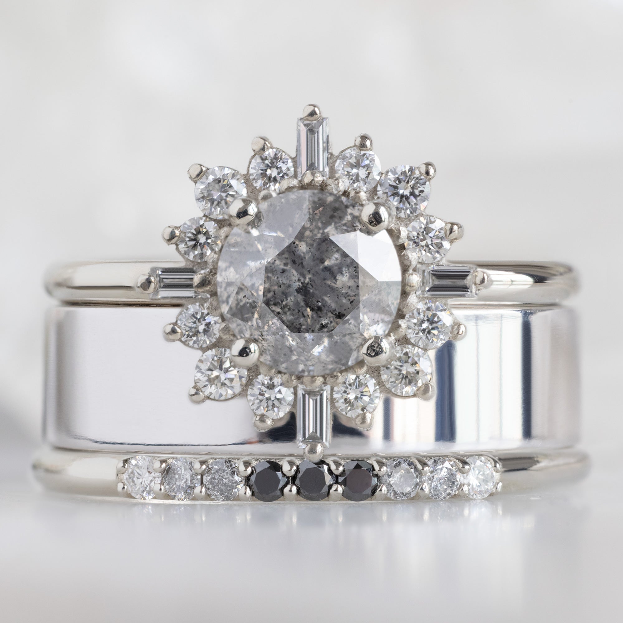 The Luxe Ombré Diamond Pavé Wedding Band in 14K White Gold Stacked with Salt and Pepper Diamond Engagement Ring on White Marble